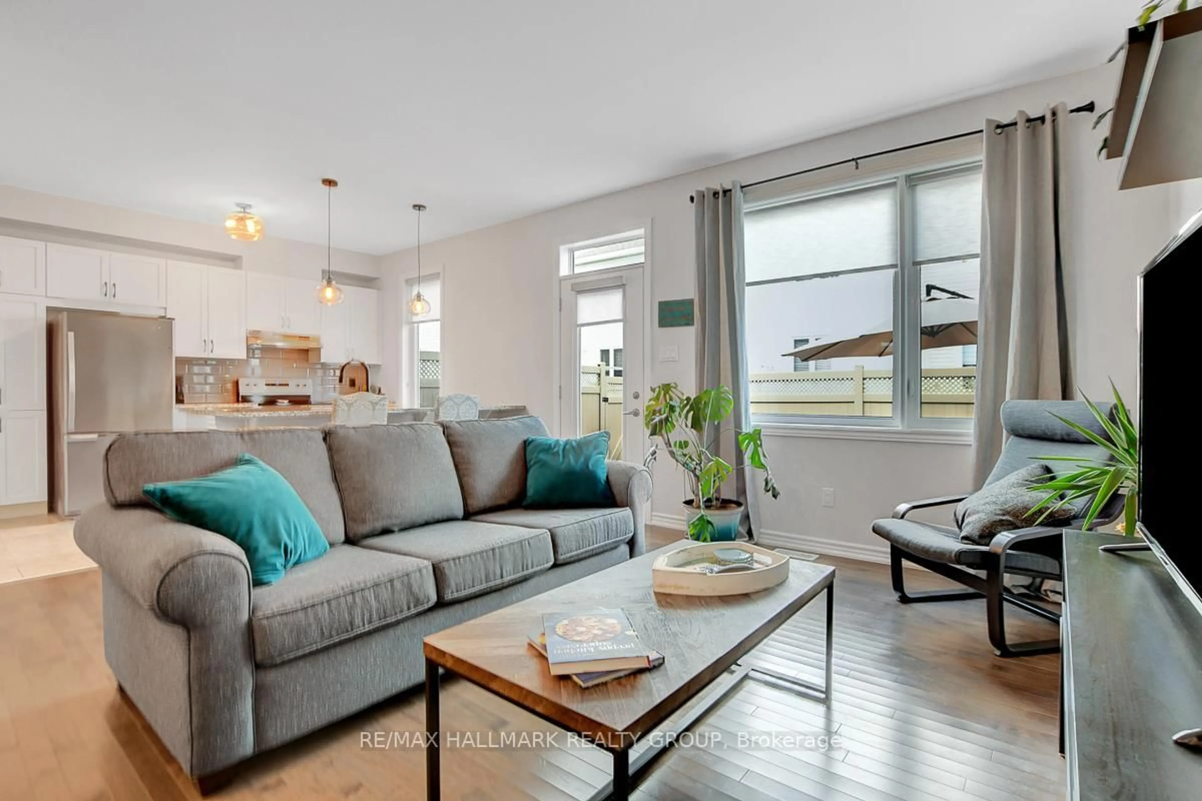 Living room with furniture, wood/laminate floor for 14 Darvoy Mews, Ottawa Ontario K1W 0M6
