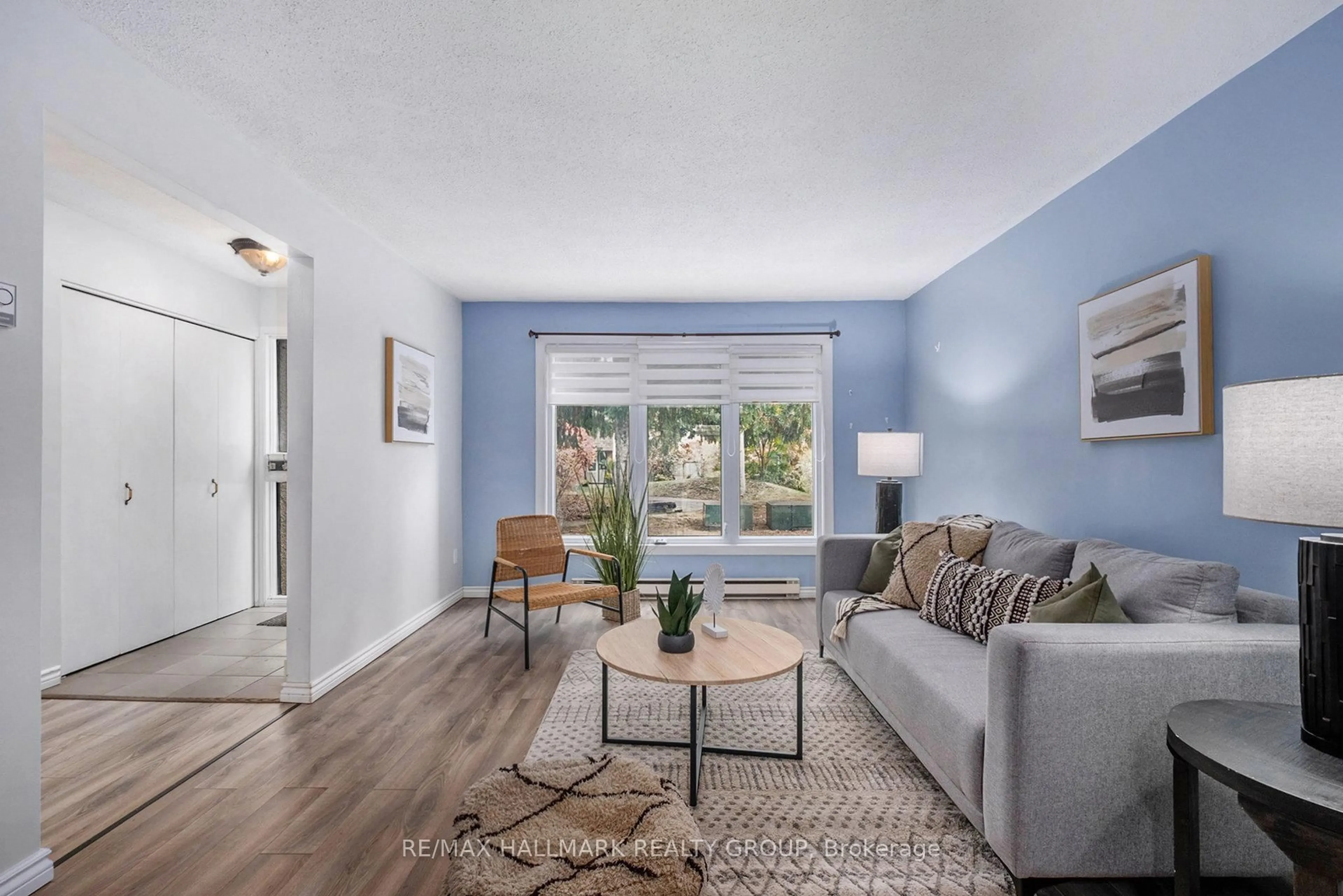 Living room with furniture, wood/laminate floor for 3691 Albion Rd #23, Ottawa Ontario K1T 1P2