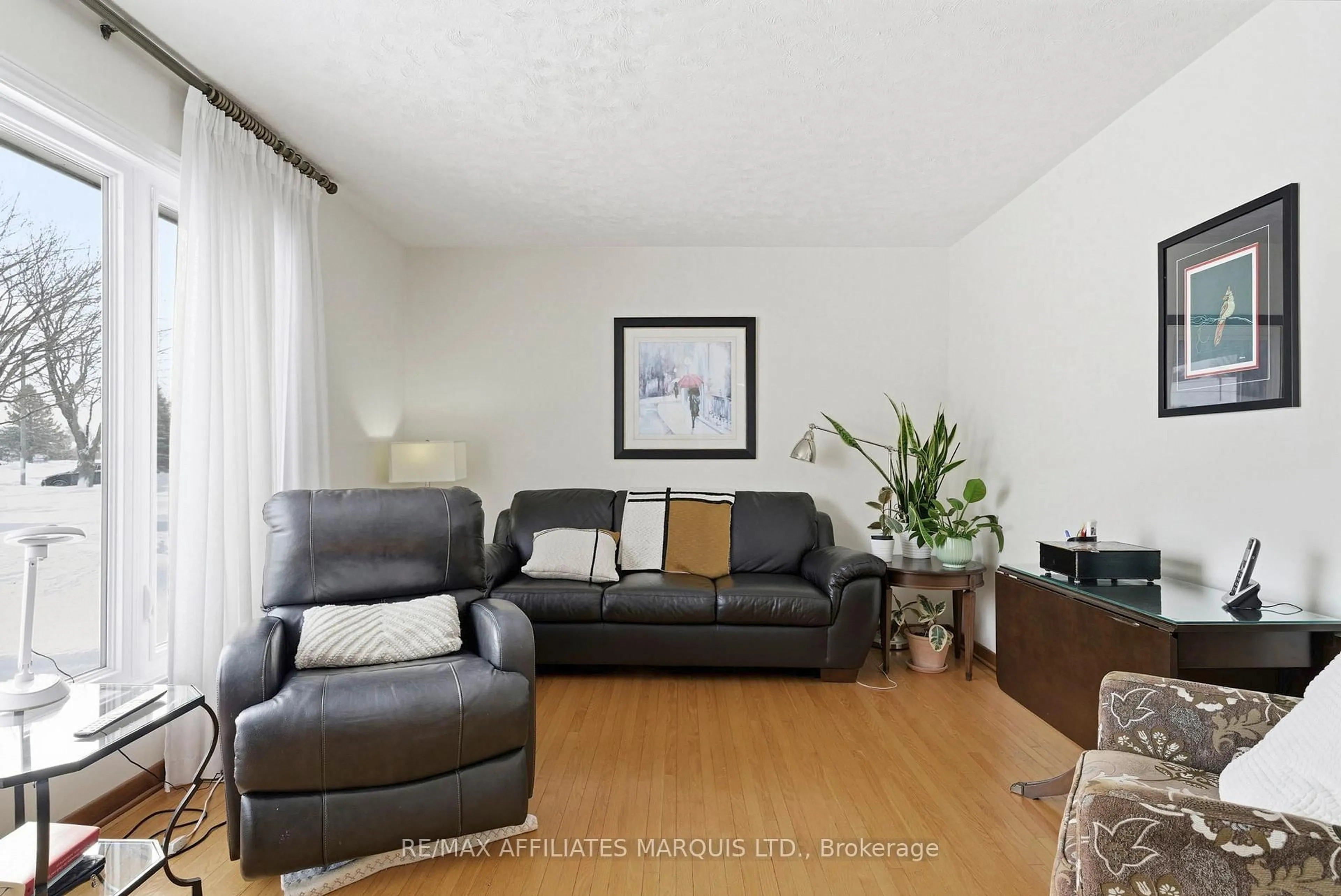 Living room with furniture, wood/laminate floor for 1340 Marc St, Cornwall Ontario K6H 3M3