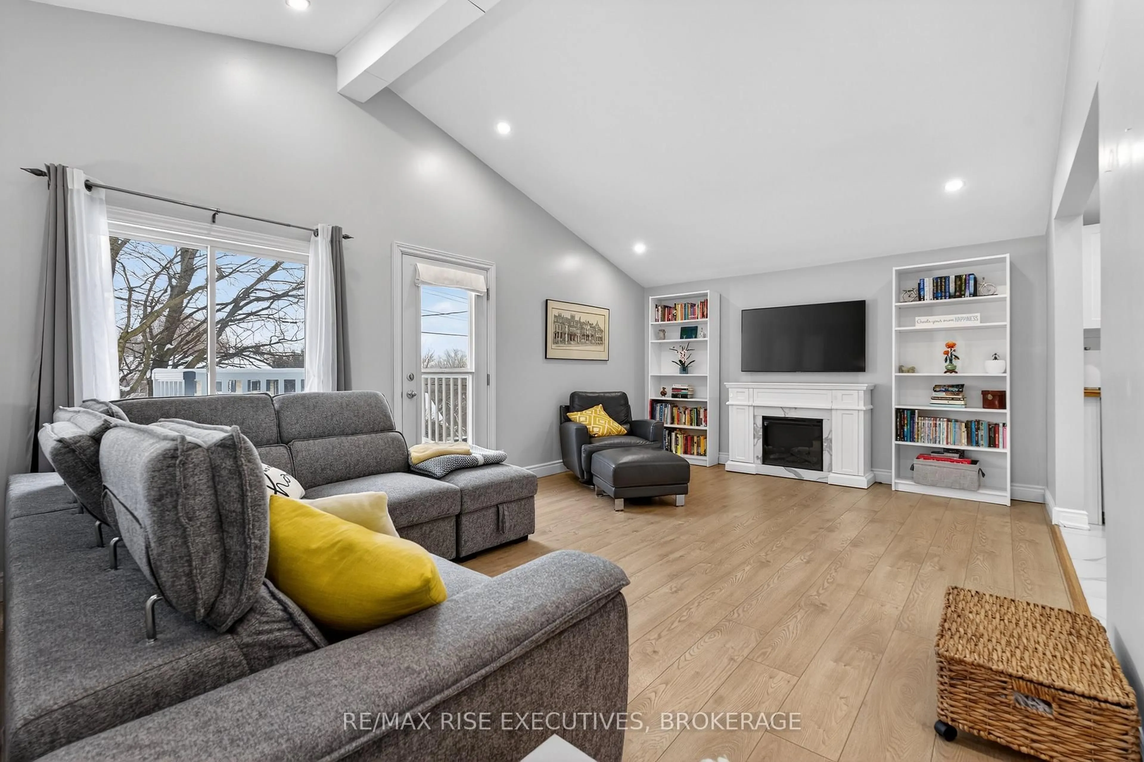 Living room with furniture, wood/laminate floor for 1302 Montreal St, Kingston Ontario K7K 3L6