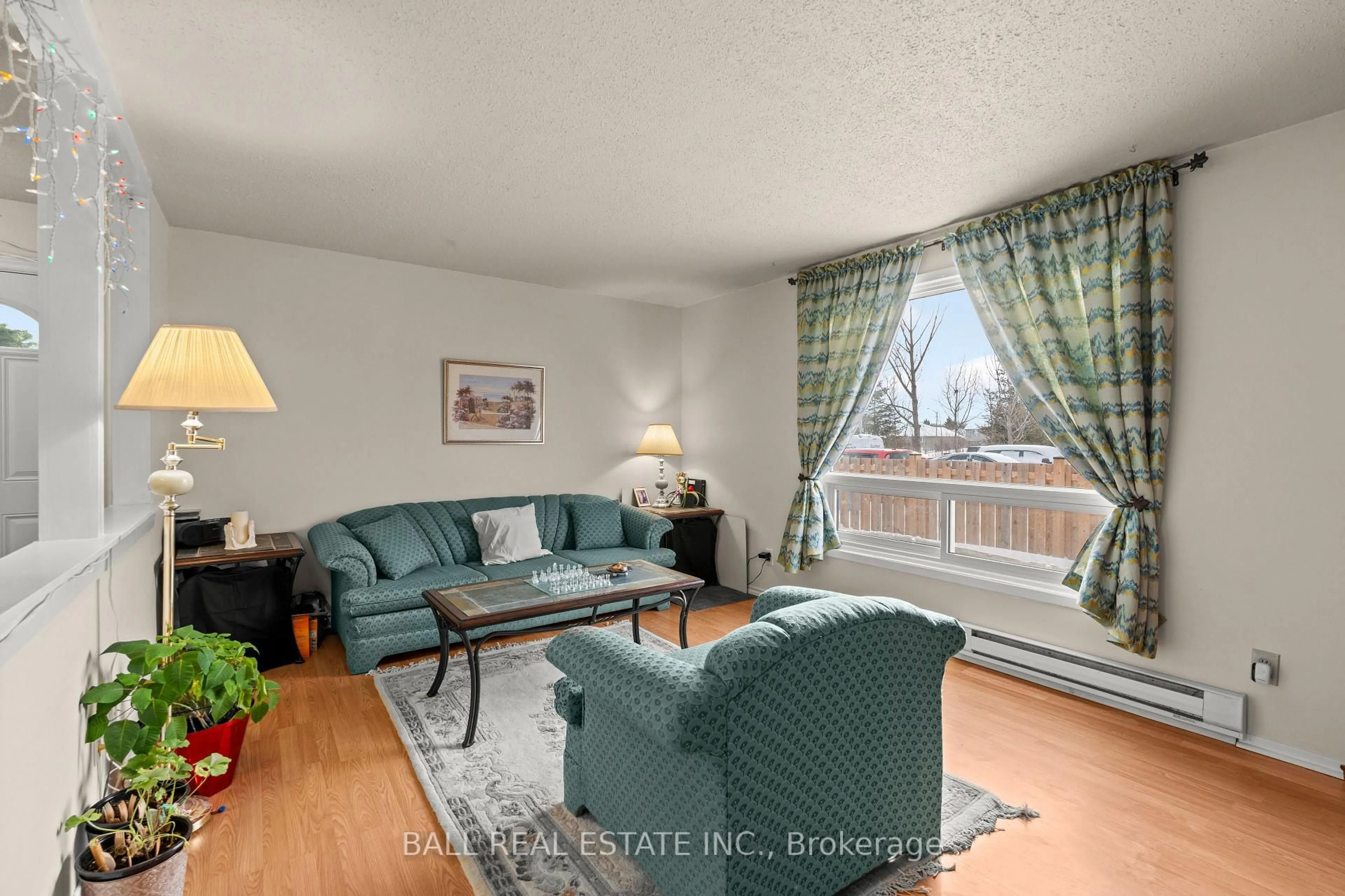 Living room with furniture, wood/laminate floor for 21 Tracey Park Dr #50, Belleville Ontario K8P 4R4