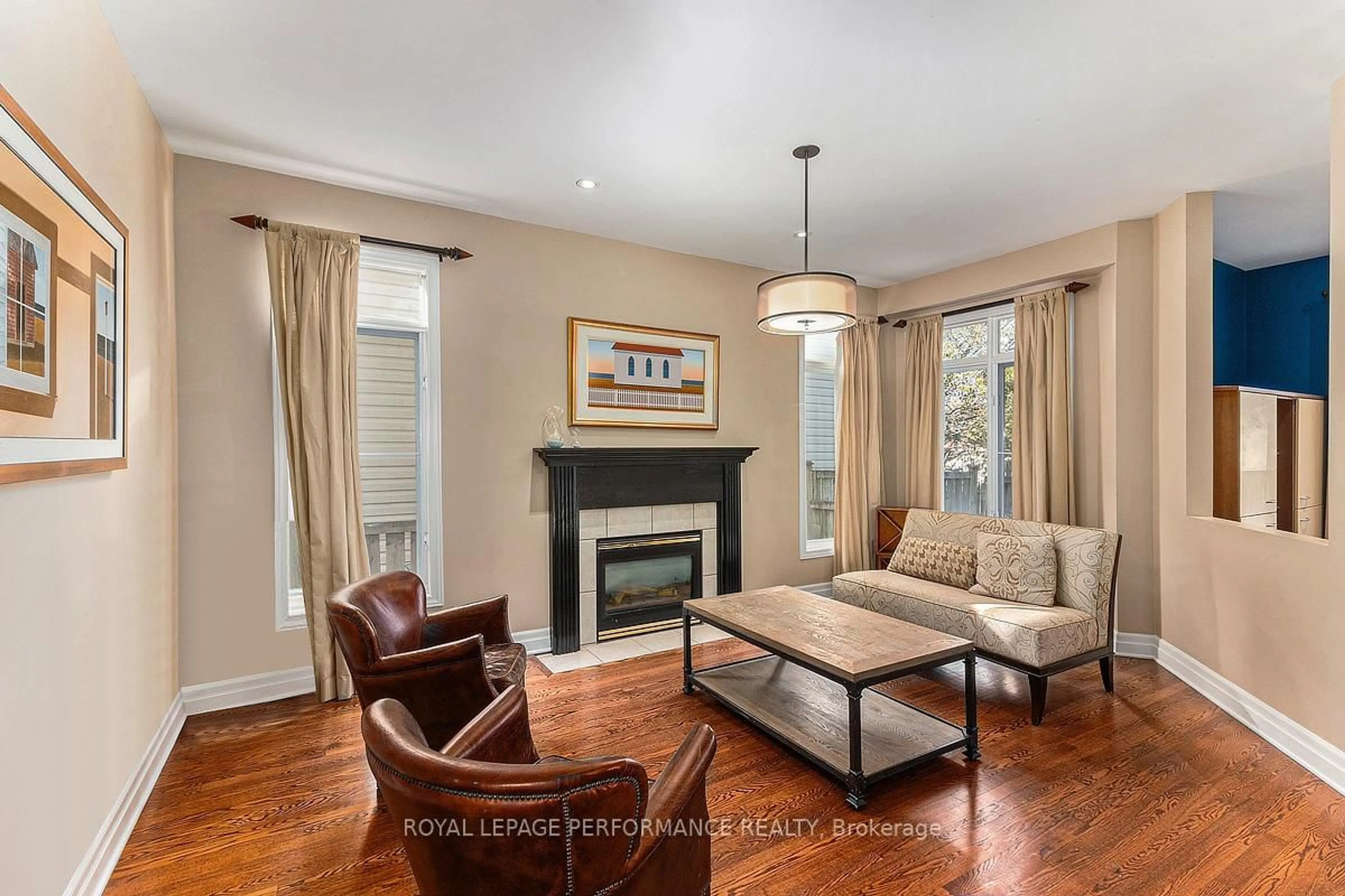 Living room with furniture, wood/laminate floor for 1386 Chicory Pl, Ottawa Ontario K1J 1E7