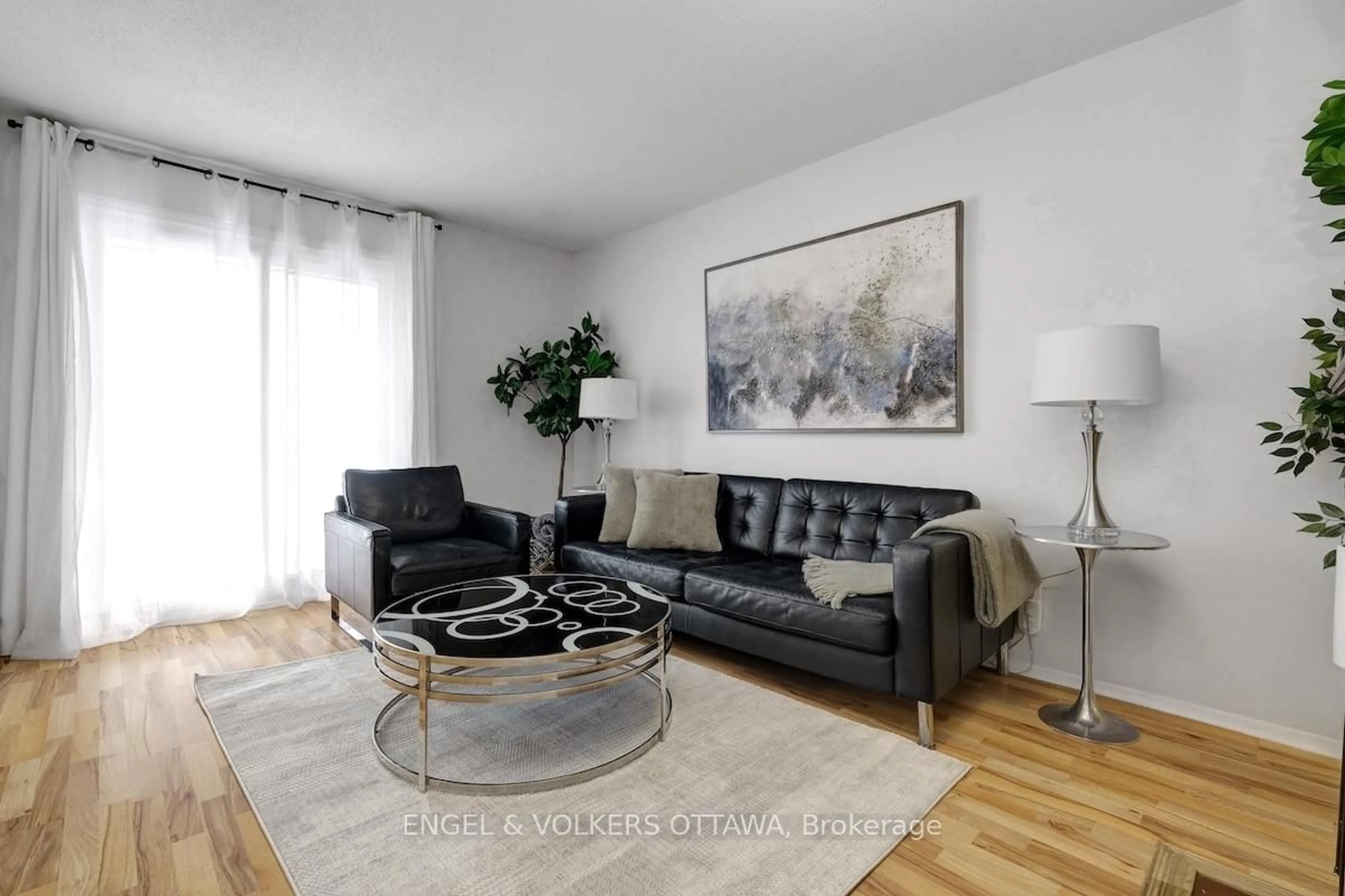 Living room with furniture, wood/laminate floor for 3445 Uplands Dr #116, Ottawa Ontario K1V 9N5