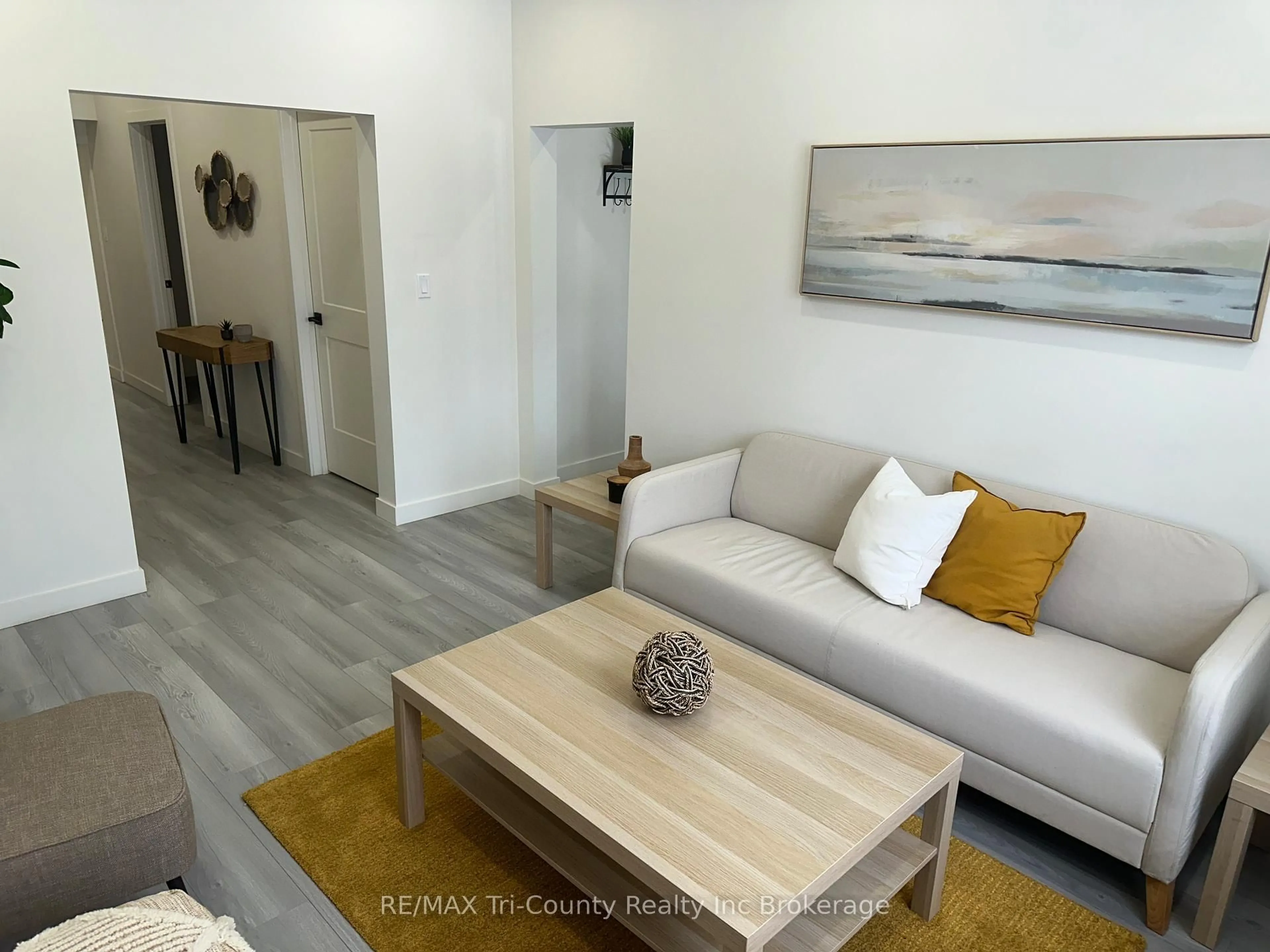 Living room with furniture, wood/laminate floor for 719 Elias St, London East Ontario N5W 3N8