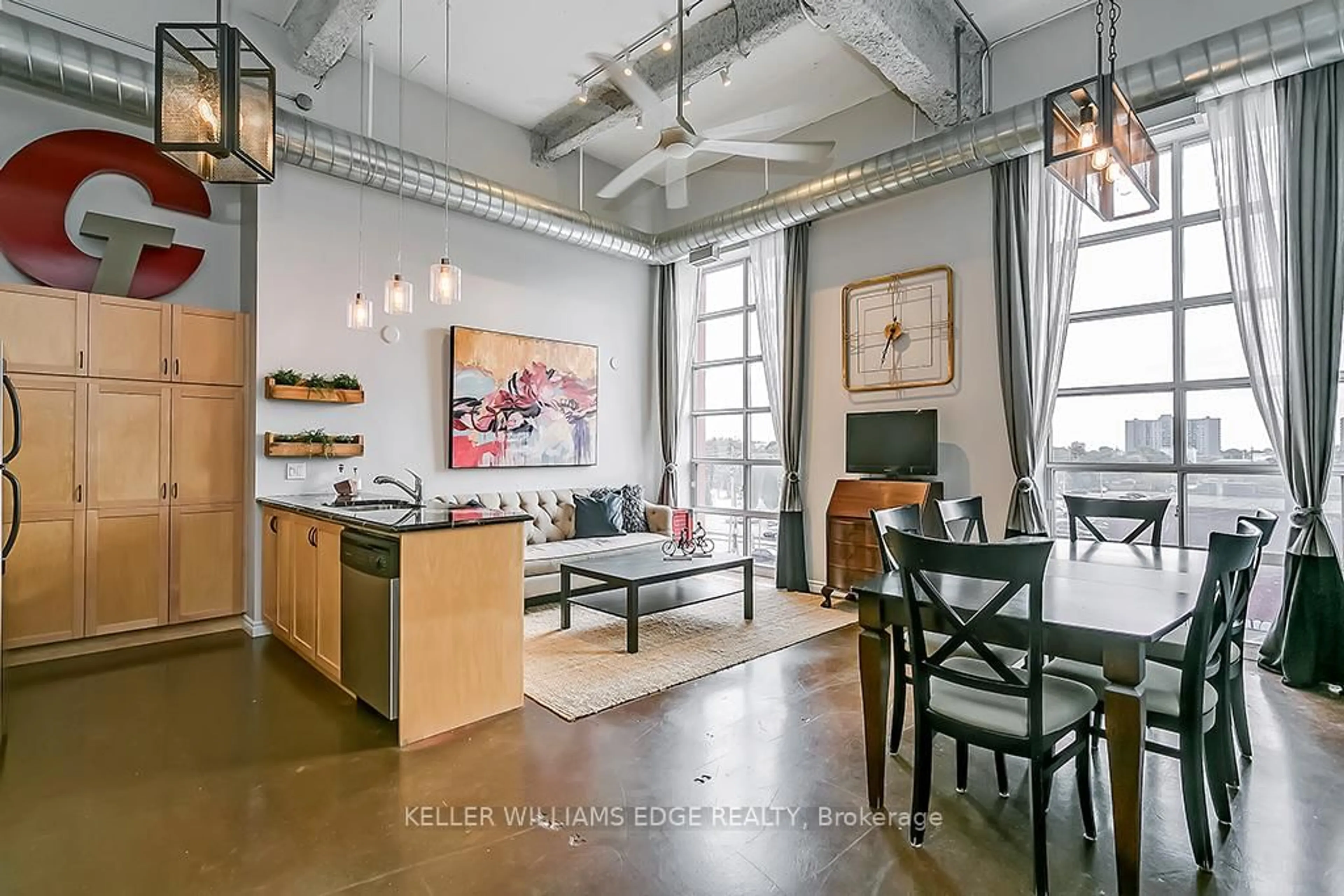 Open concept kitchen, cement floor for 11 Rebecca St #311, Hamilton Ontario L8R 3H7