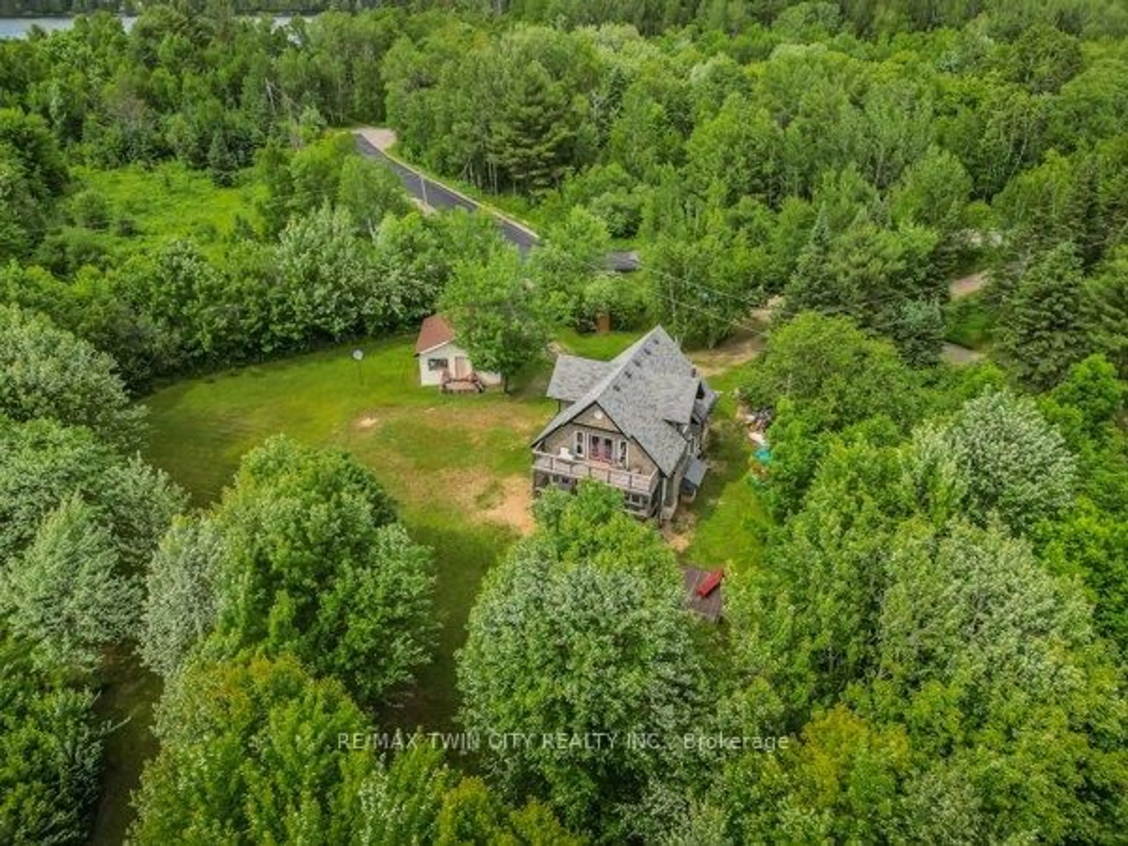 A pic from outside/outdoor area/front of a property/back of a property/a pic from drone, forest/trees view for 5 Bridge Rd, Magnetawan Ontario P0A 1P0