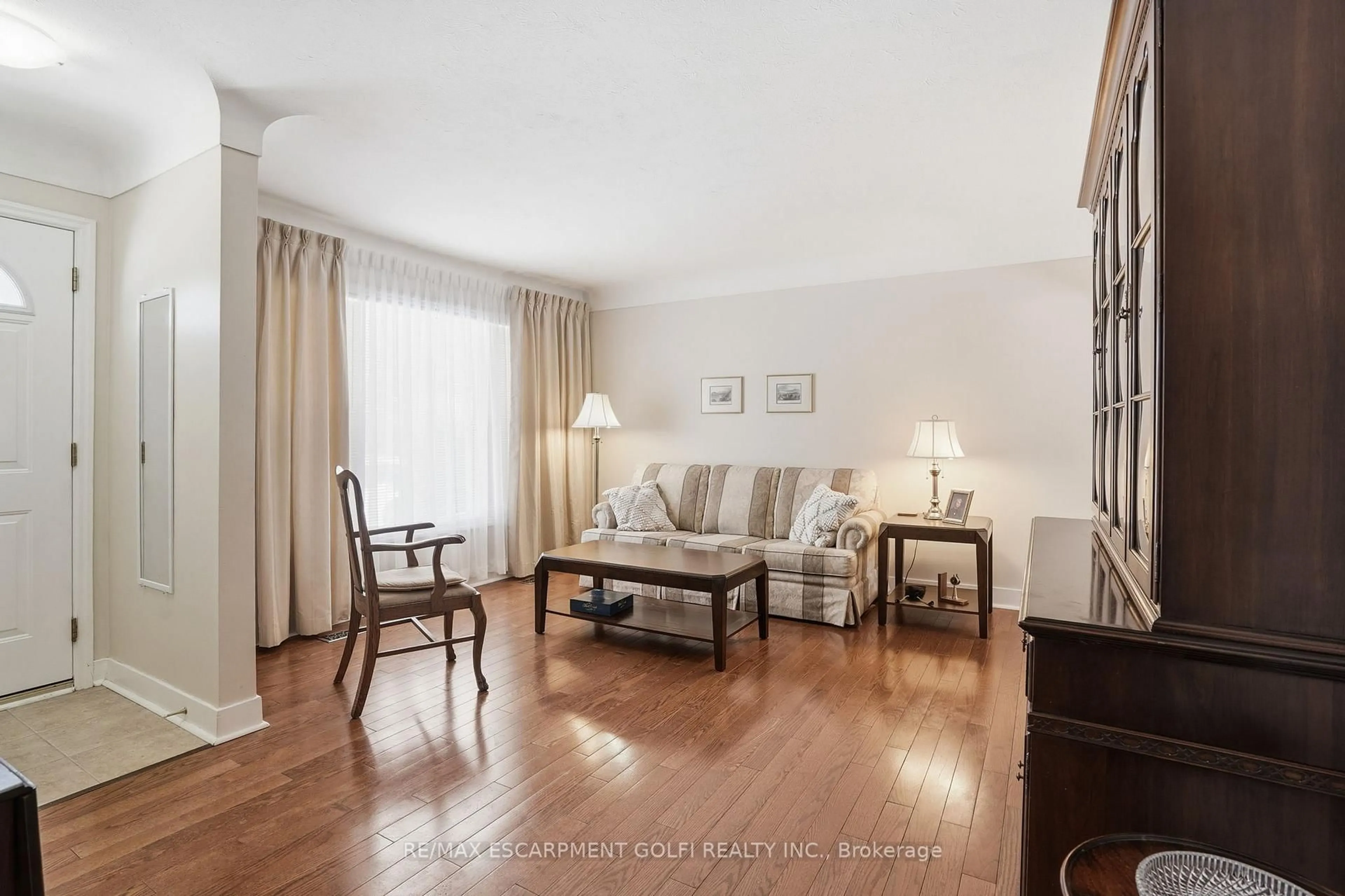 Living room with furniture, wood/laminate floor for 77 Jacobson Ave, St. Catharines Ontario L2T 3A2