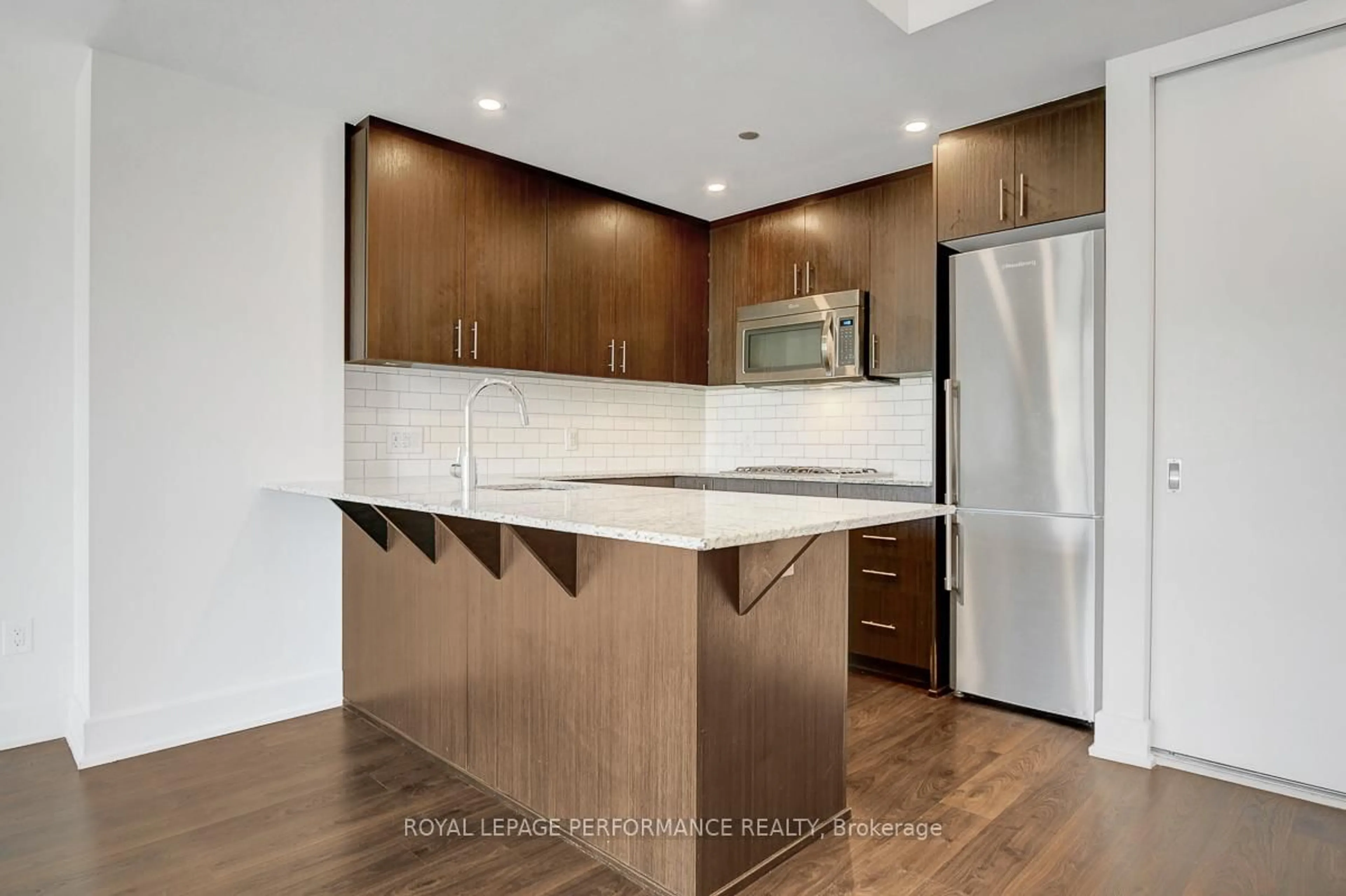 Open concept kitchen, wood/laminate floor for 7 Marquette Ave #413, Ottawa Ontario K1L 8A7