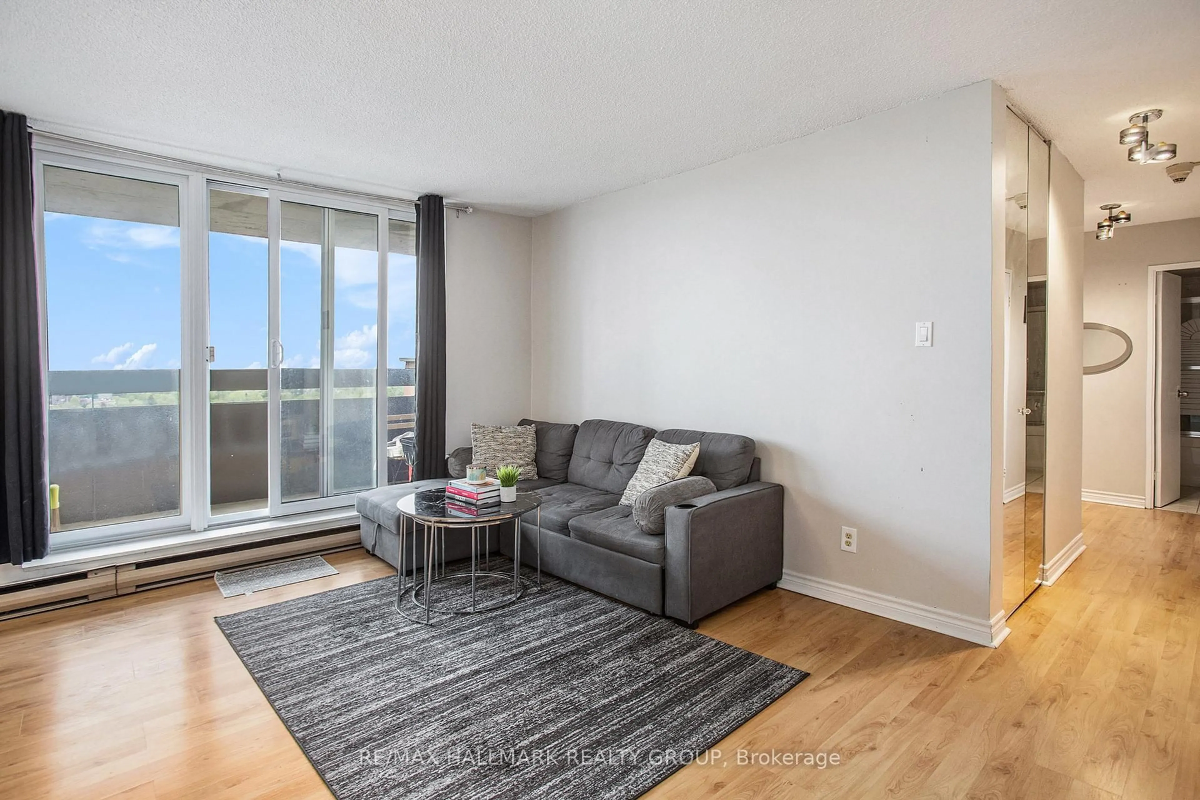 Living room with furniture, wood/laminate floor for 2000 Jasmine Cres #1508, Ottawa Ontario K1J 8K4