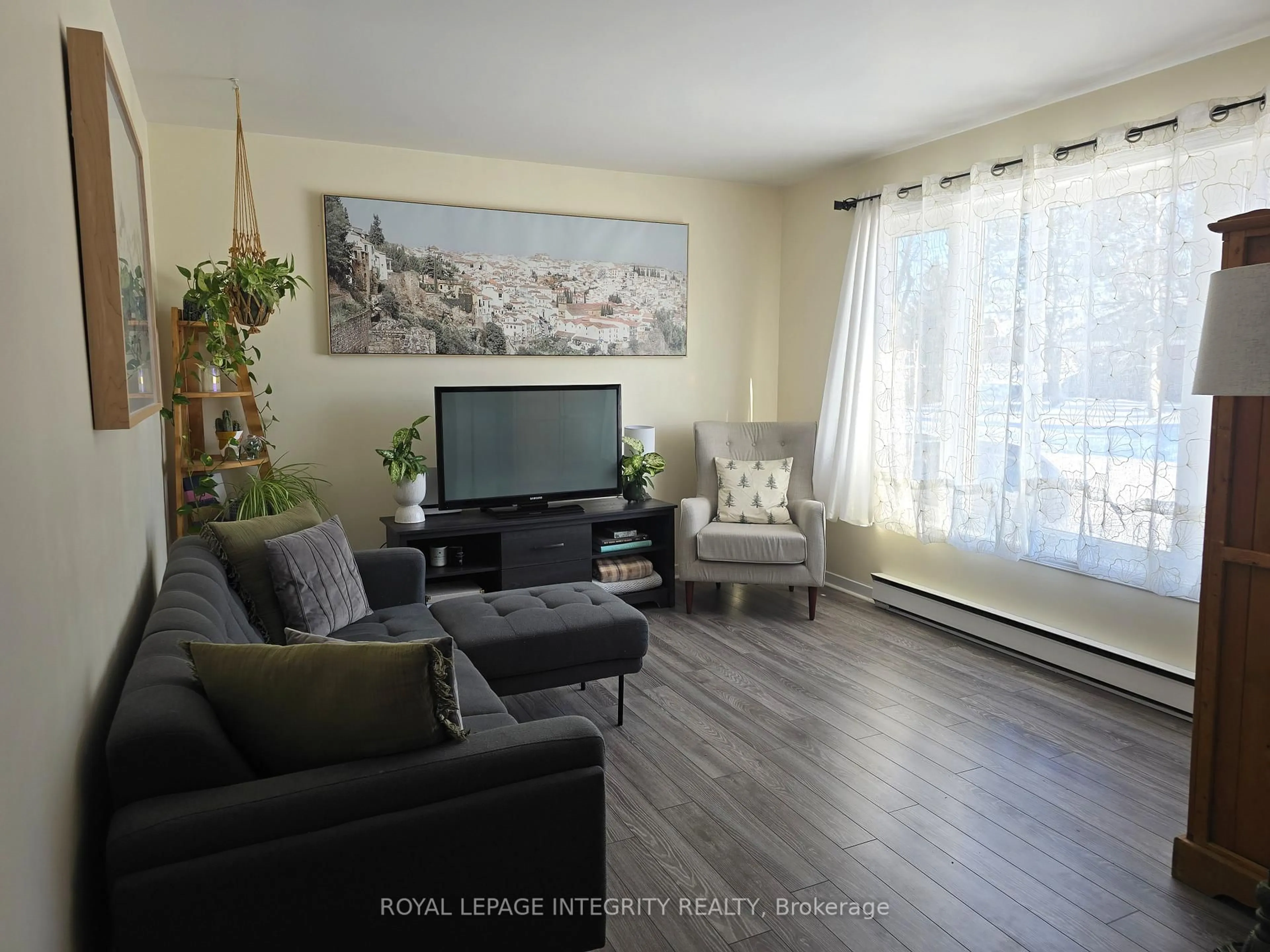 Living room with furniture, wood/laminate floor for 3264 Johnston Ave, Cornwall Ontario K6K 1H3