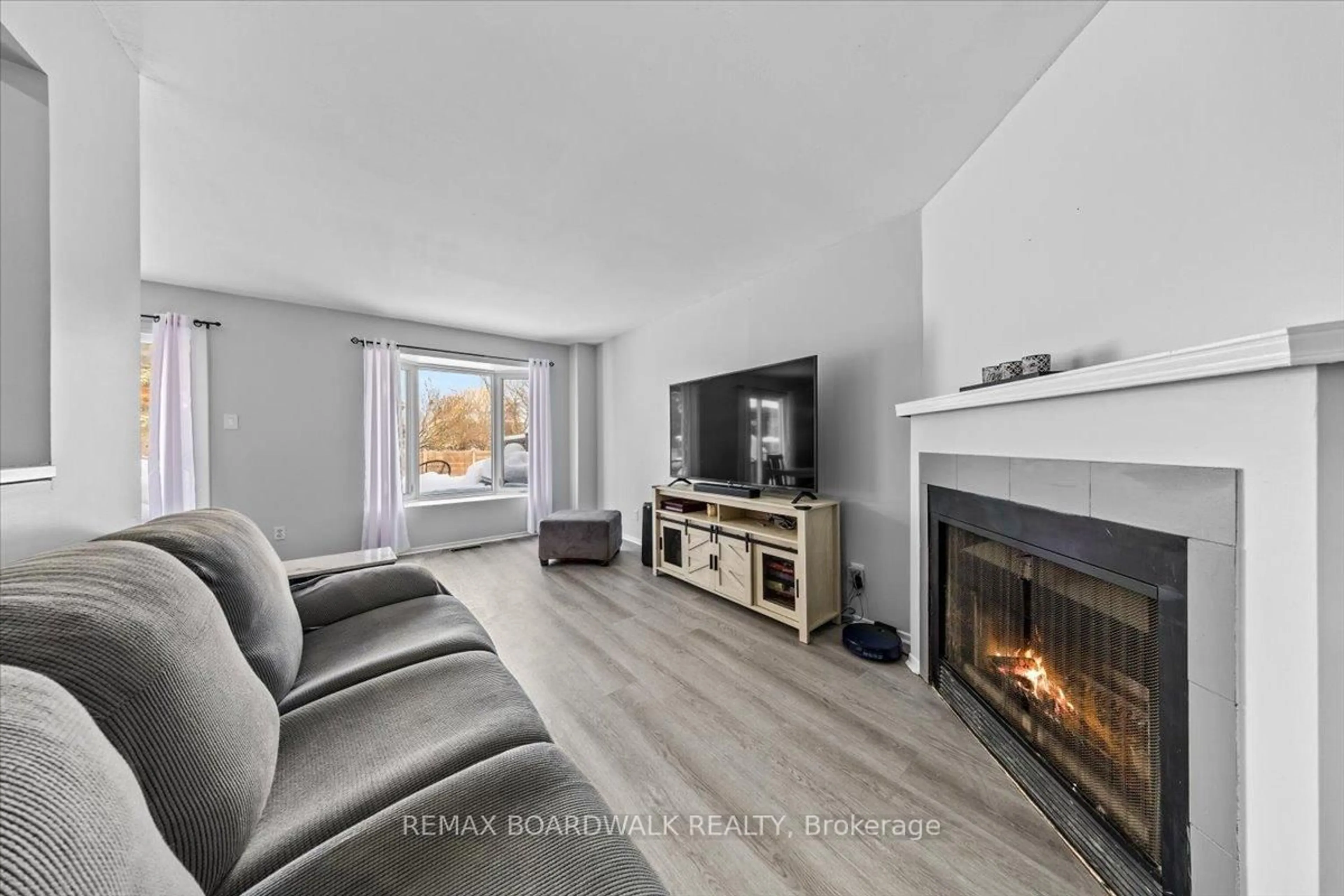 Living room with furniture, wood/laminate floor for 294 Valade Cres, Orleans Ontario K4A 2X3