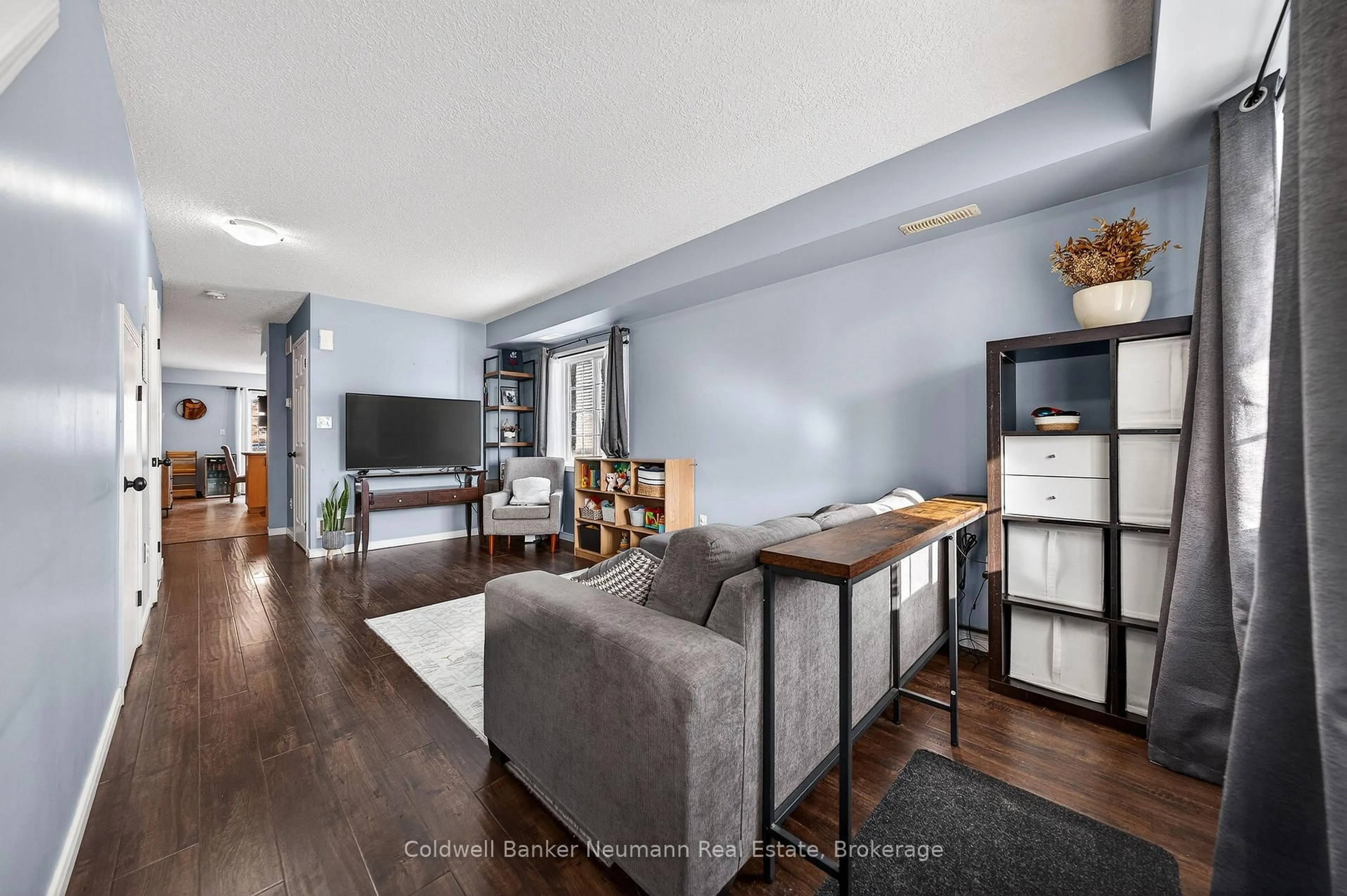 Living room with furniture, wood/laminate floor for 35 Mountford Dr #107, Guelph Ontario N1E 0G6