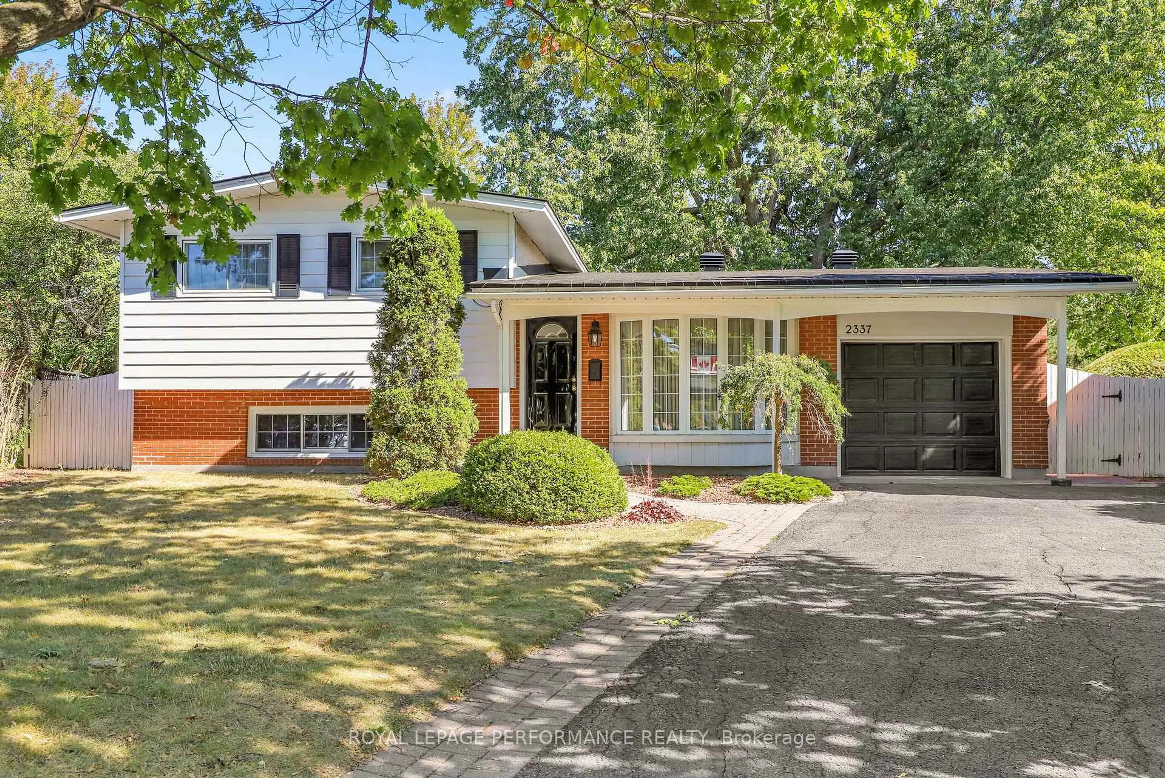 Home with vinyl exterior material, street for 2337 Samuel Dr, Ottawa Ontario K1G 3C3