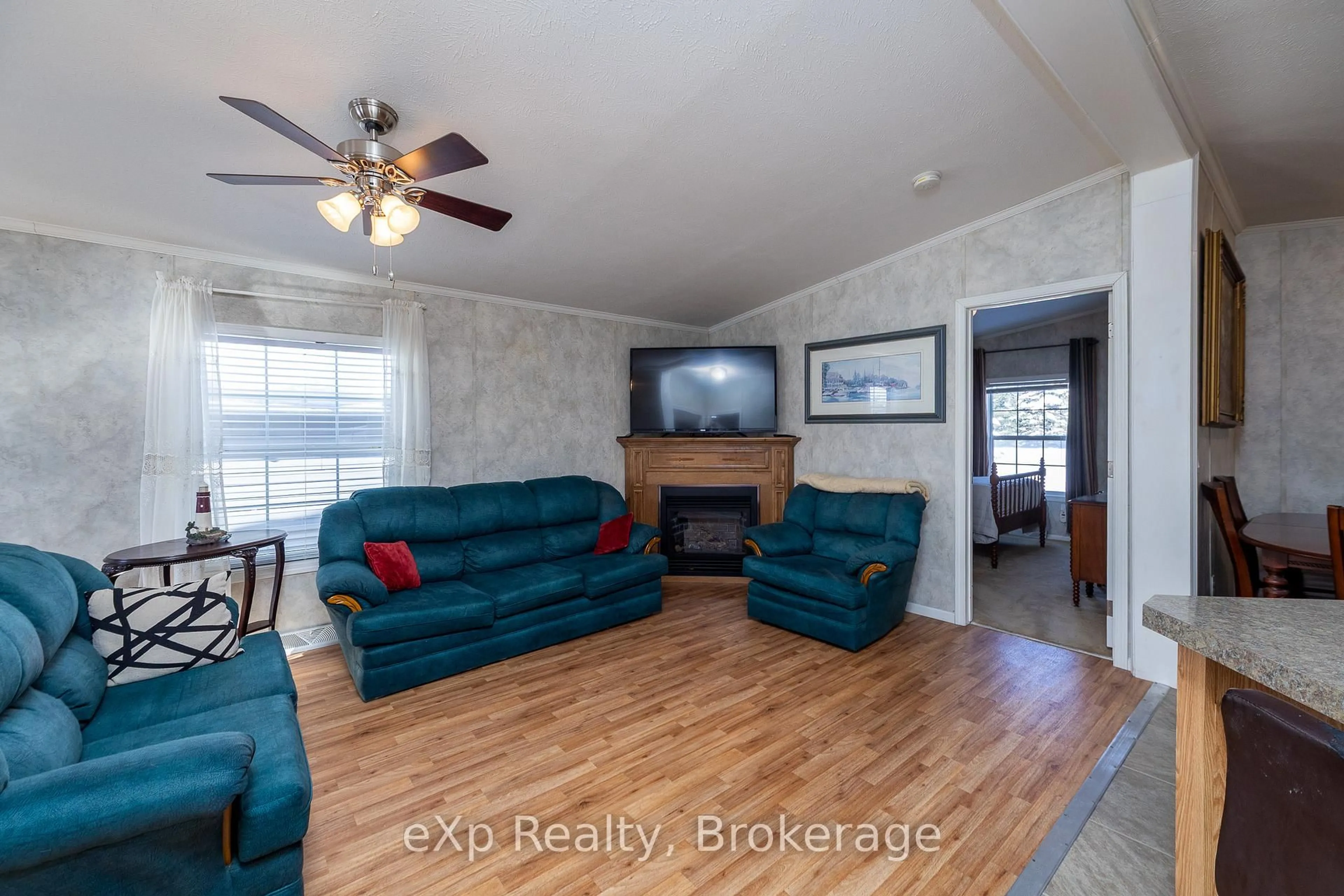 Living room with furniture, wood/laminate floor for 110 Rosewood Dr, Georgian Bluffs Ontario N4K 5N5
