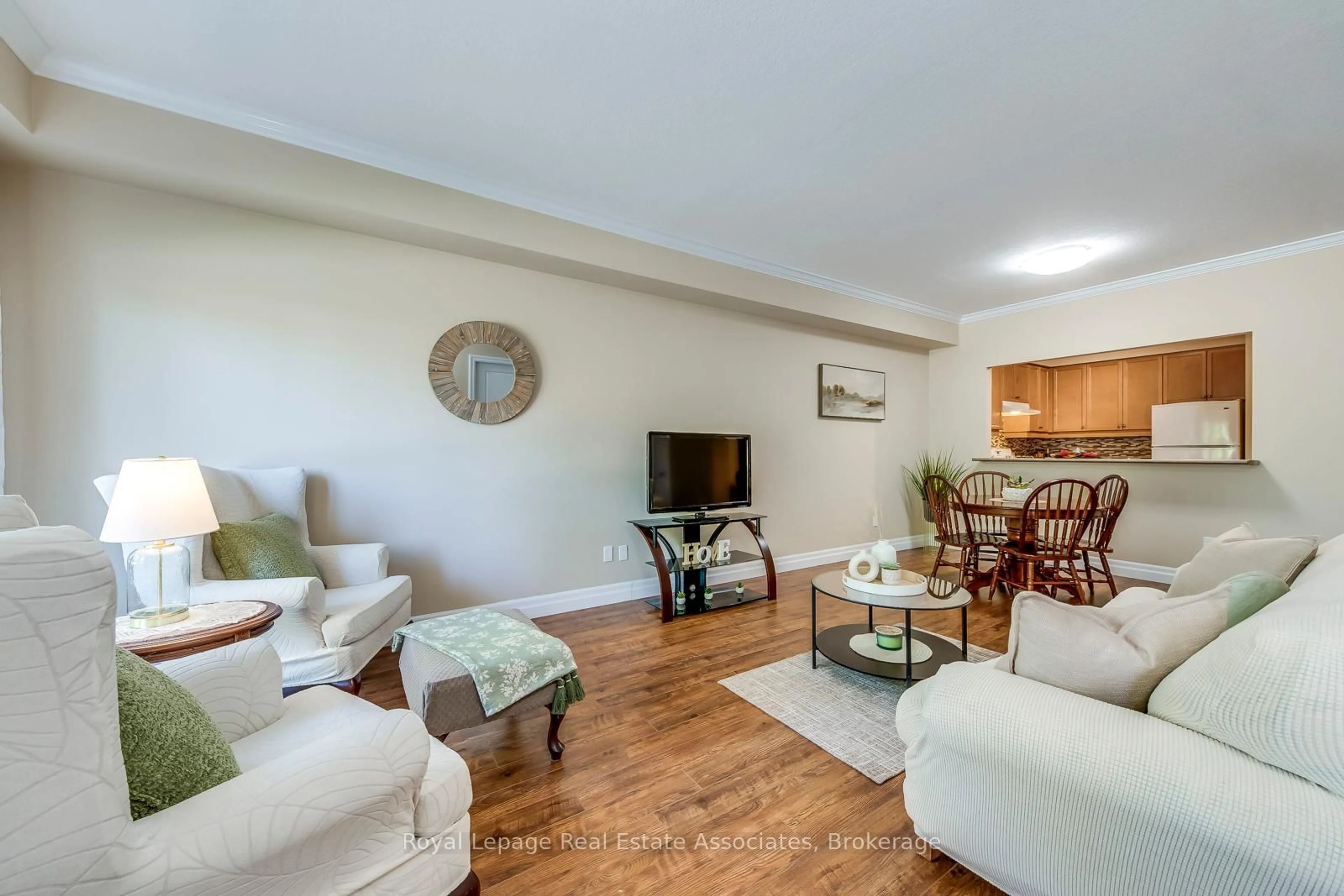 Living room with furniture, wood/laminate floor for 760 Woodhill Dr #221, Centre Wellington Ontario N1M 3W5