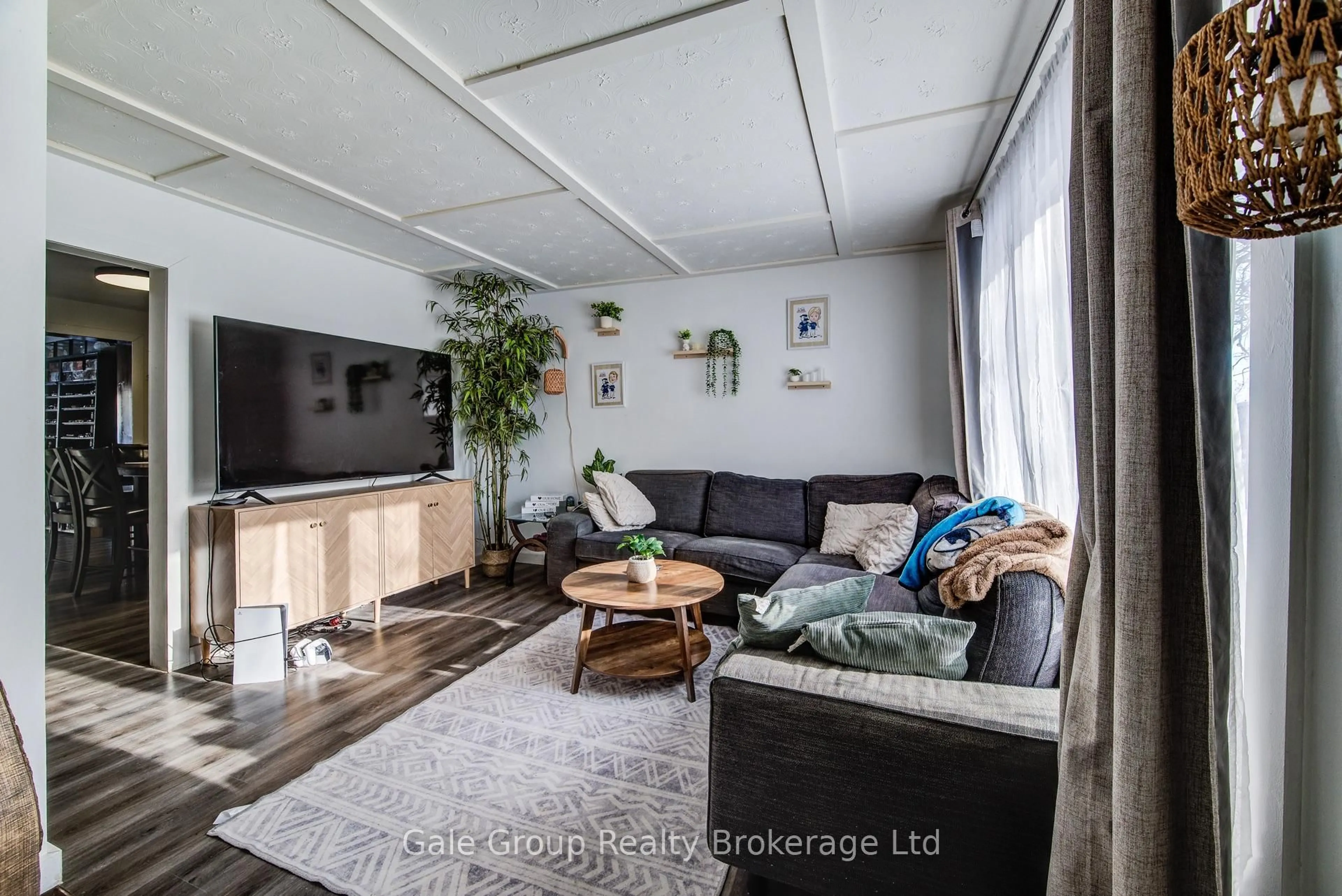 Living room with furniture, wood/laminate floor for 393 Odlum Dr, Woodstock Ontario N4S 3S1