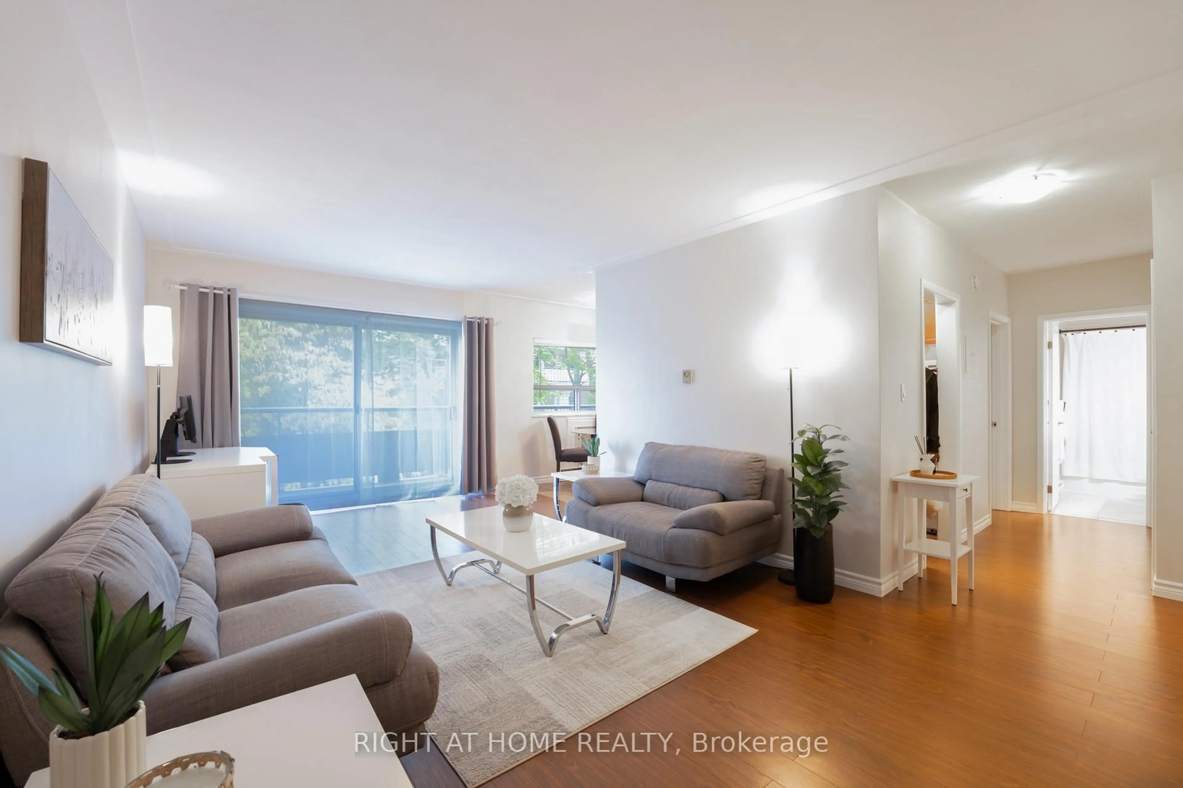 Living room with furniture, wood/laminate floor for 11 Woodman Dr #211, Hamilton Ontario L8K 4E3