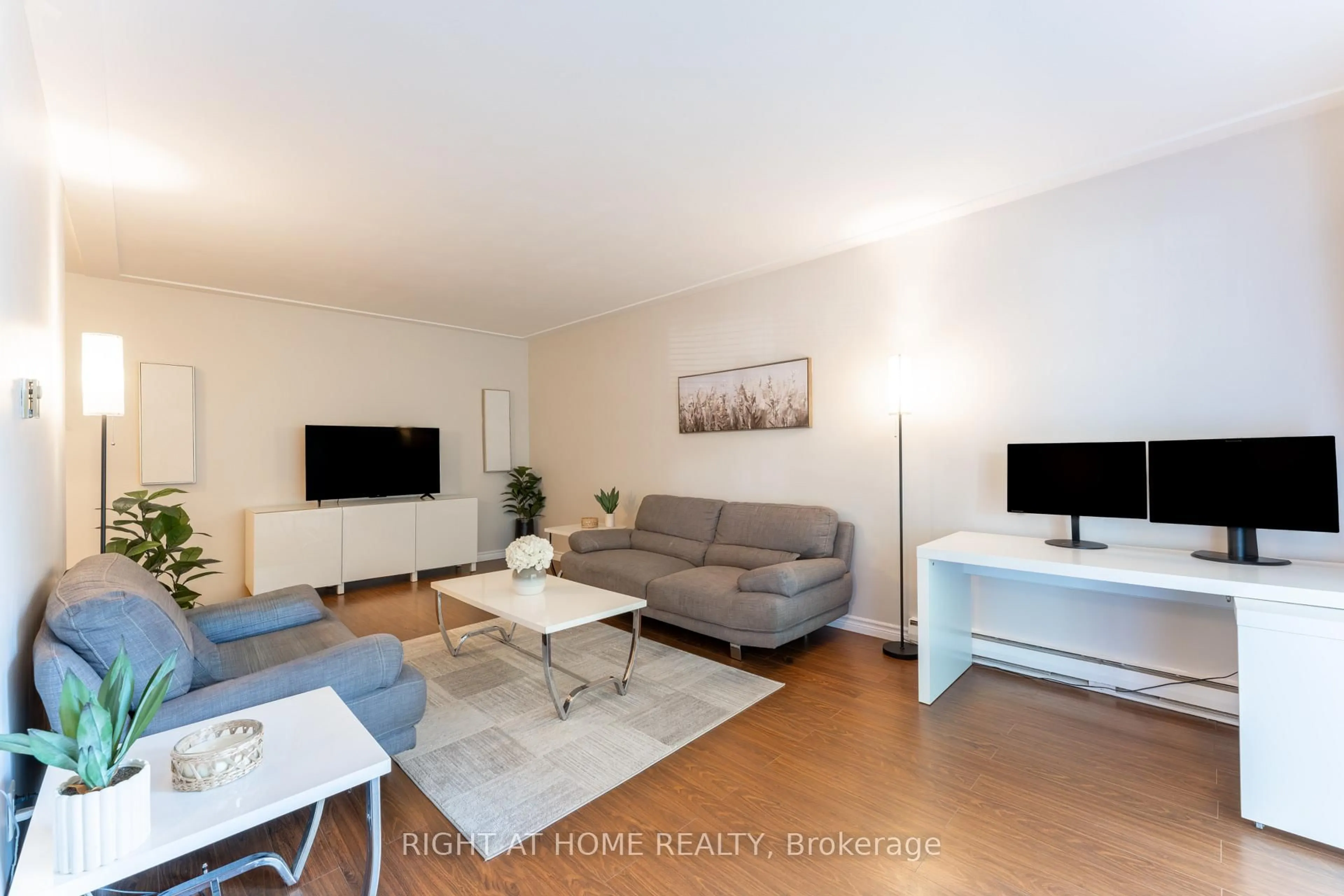 Living room with furniture, wood/laminate floor for 11 Woodman Dr #211, Hamilton Ontario L8K 4E3