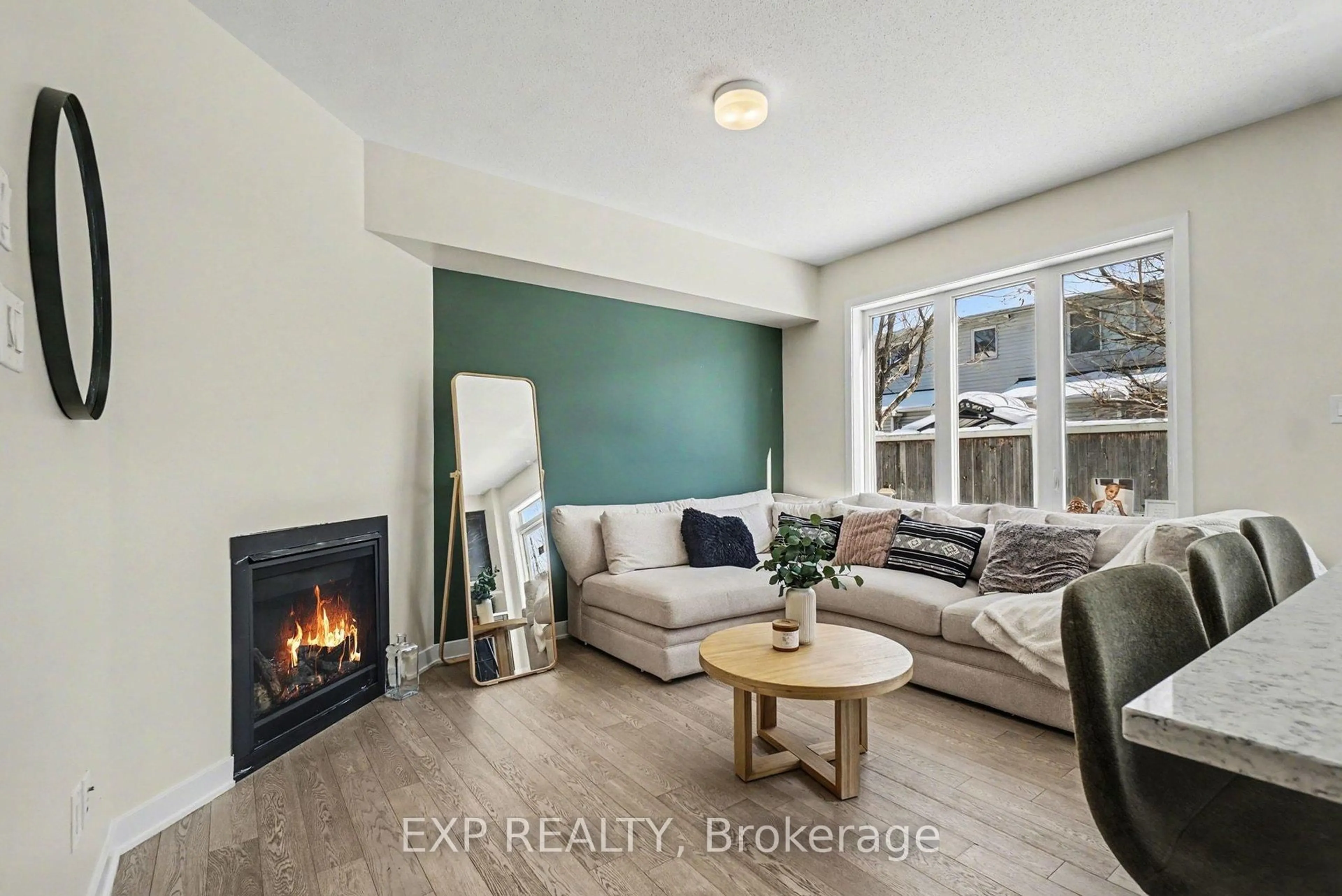 Living room with furniture, wood/laminate floor for 2142 Winsome Terr, Ottawa Ontario K4A 0K6