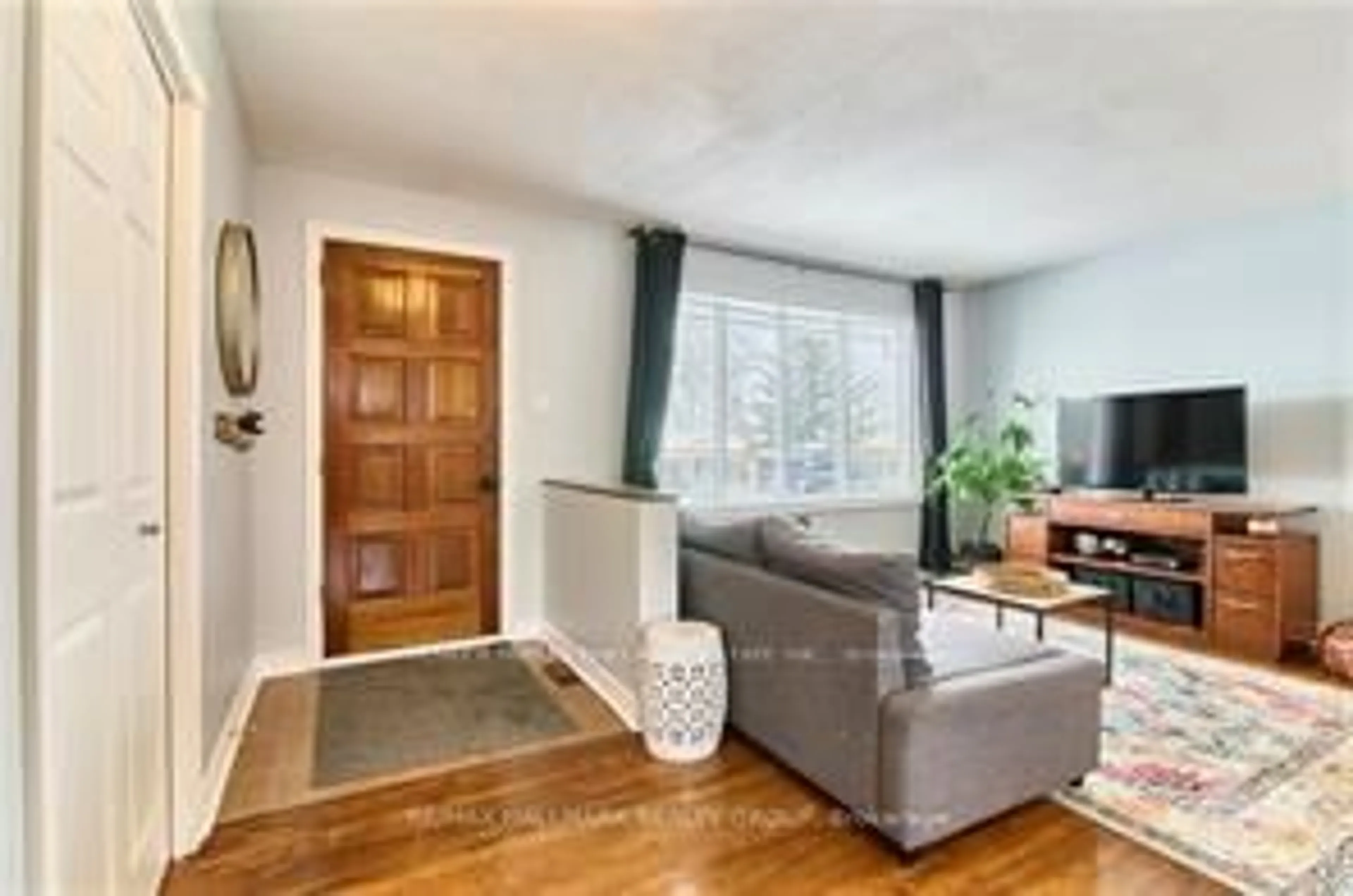 Living room with furniture, wood/laminate floor for 841 Balsam Dr, Ottawa Ontario K1E 1B8