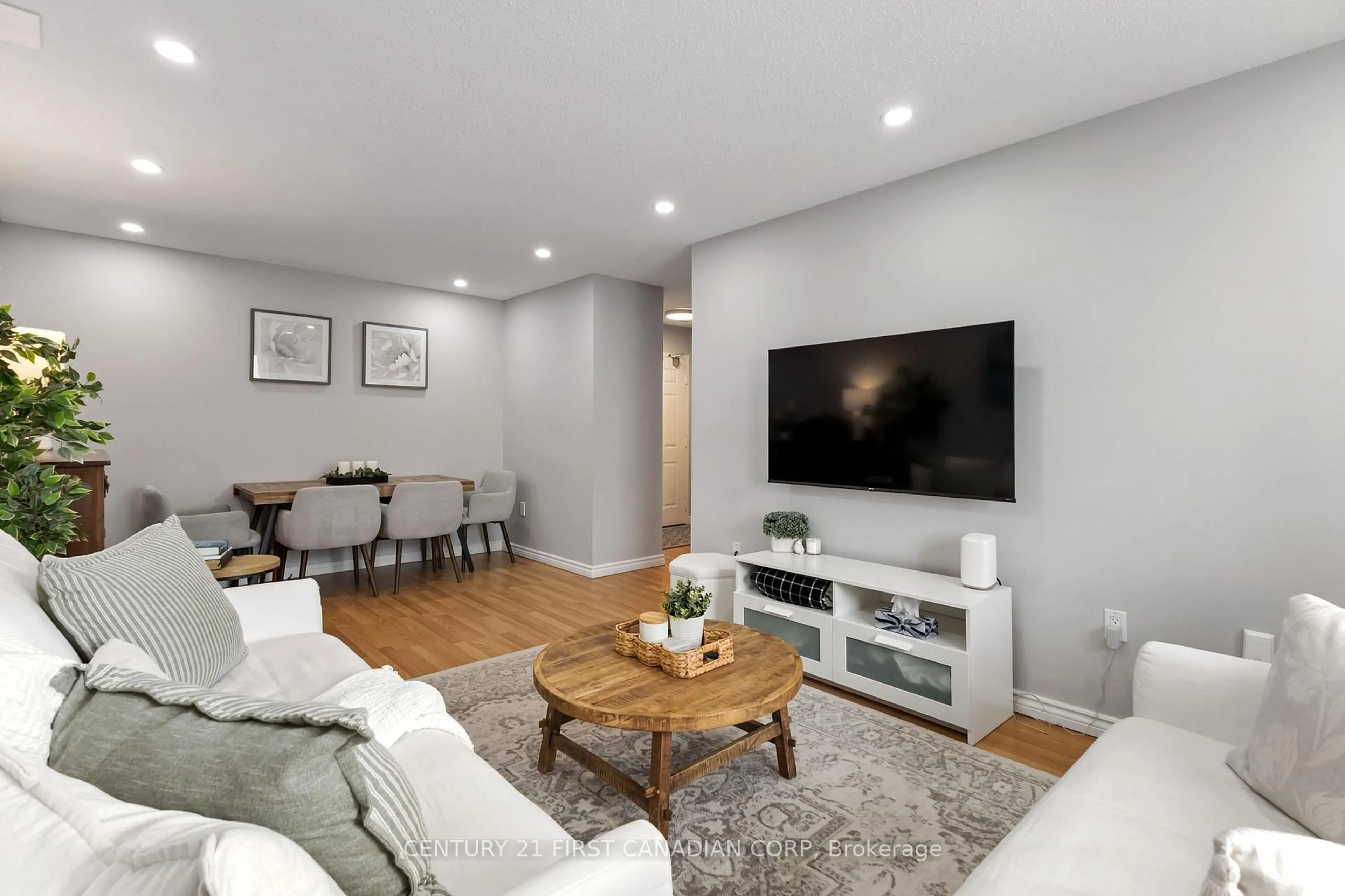 Living room with furniture, wood/laminate floor for 95 Base Line Rd #1003, London South Ontario N6J 4X3