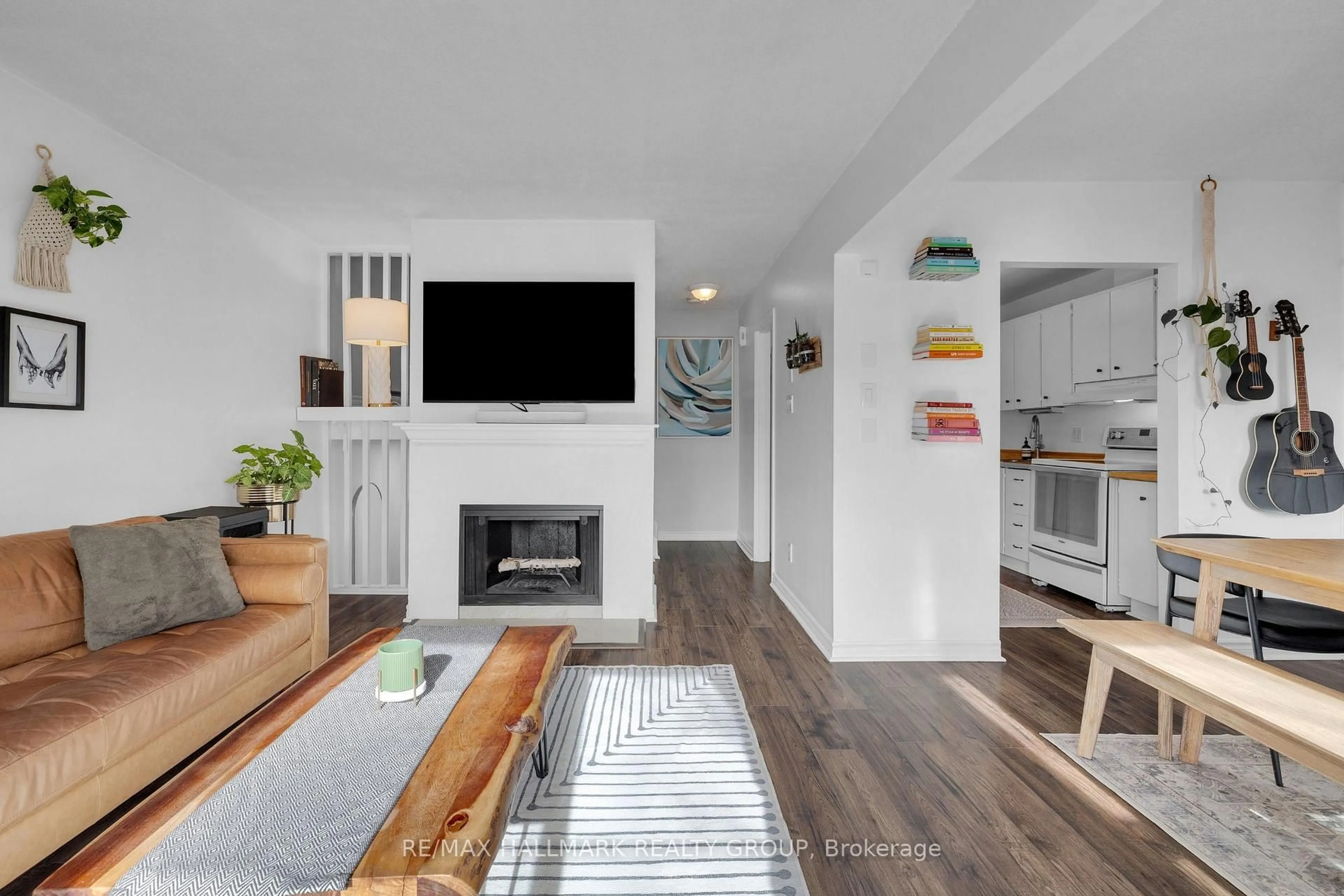 Living room with furniture, wood/laminate floor for 3445 Uplands Dr #129, Ottawa Ontario K1V 9N5