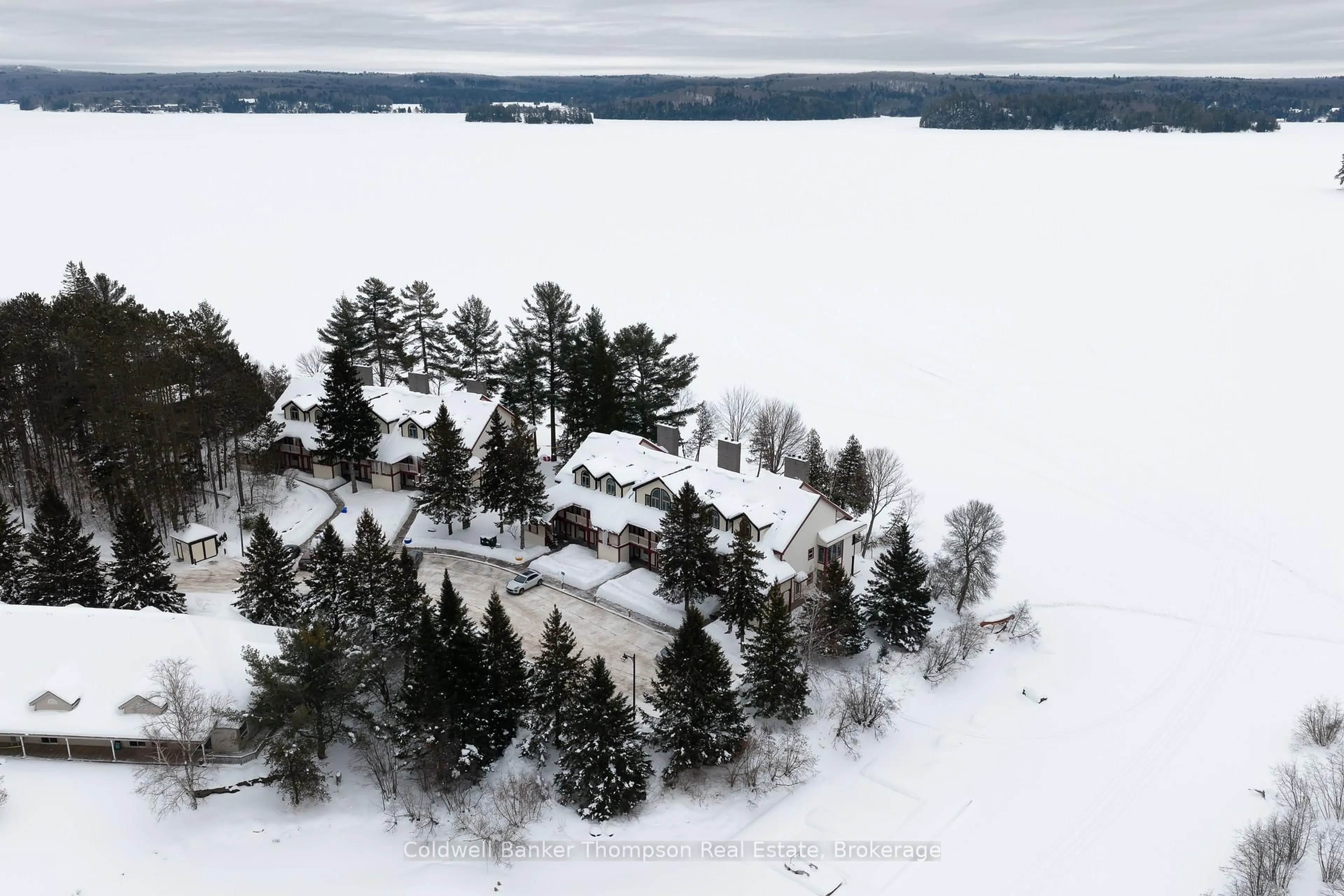 A pic from outside/outdoor area/front of a property/back of a property/a pic from drone, unknown for 10 Coveside Dr #204, Huntsville Ontario P1H 1C3