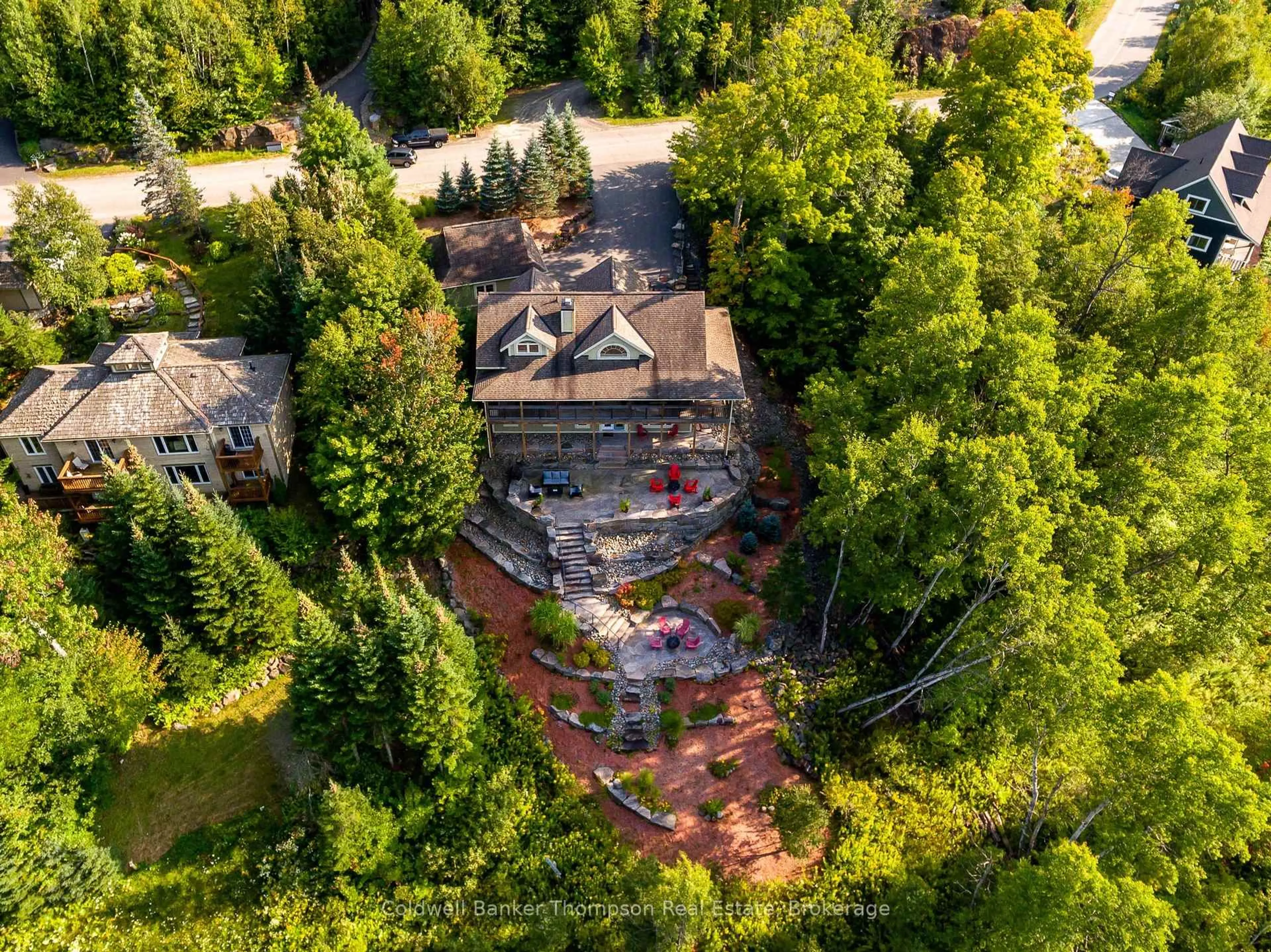 A pic from outside/outdoor area/front of a property/back of a property/a pic from drone, forest/trees view for 21 Deerhurst Highlands Dr, Huntsville Ontario P1H 1B1