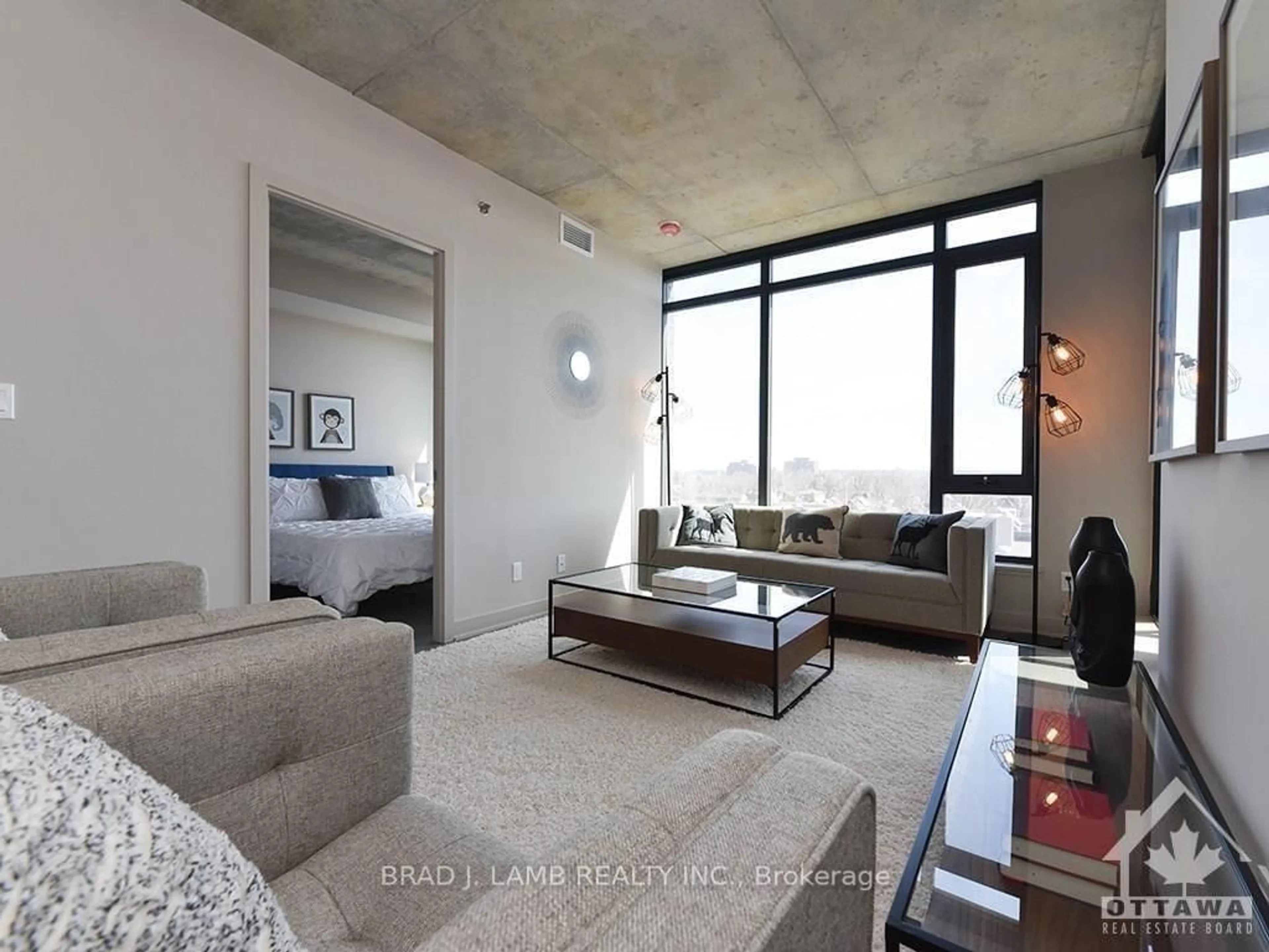 Living room with furniture, cement floor for 203 CATHERINE St #209, Ottawa Ontario K2P 1J5