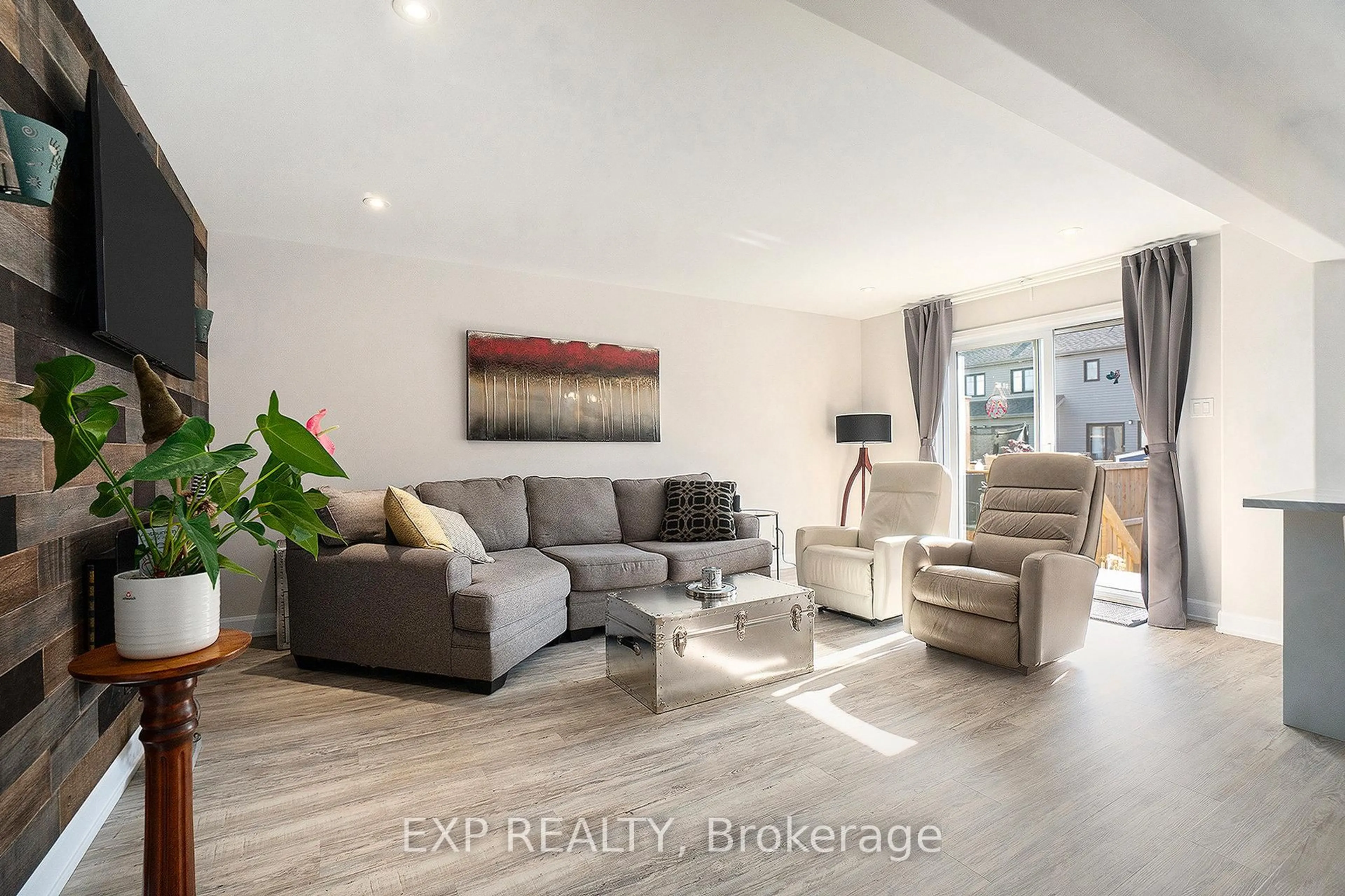 Living room with furniture, wood/laminate floor for 704 Azure St, Russell Ontario K4R 1E5