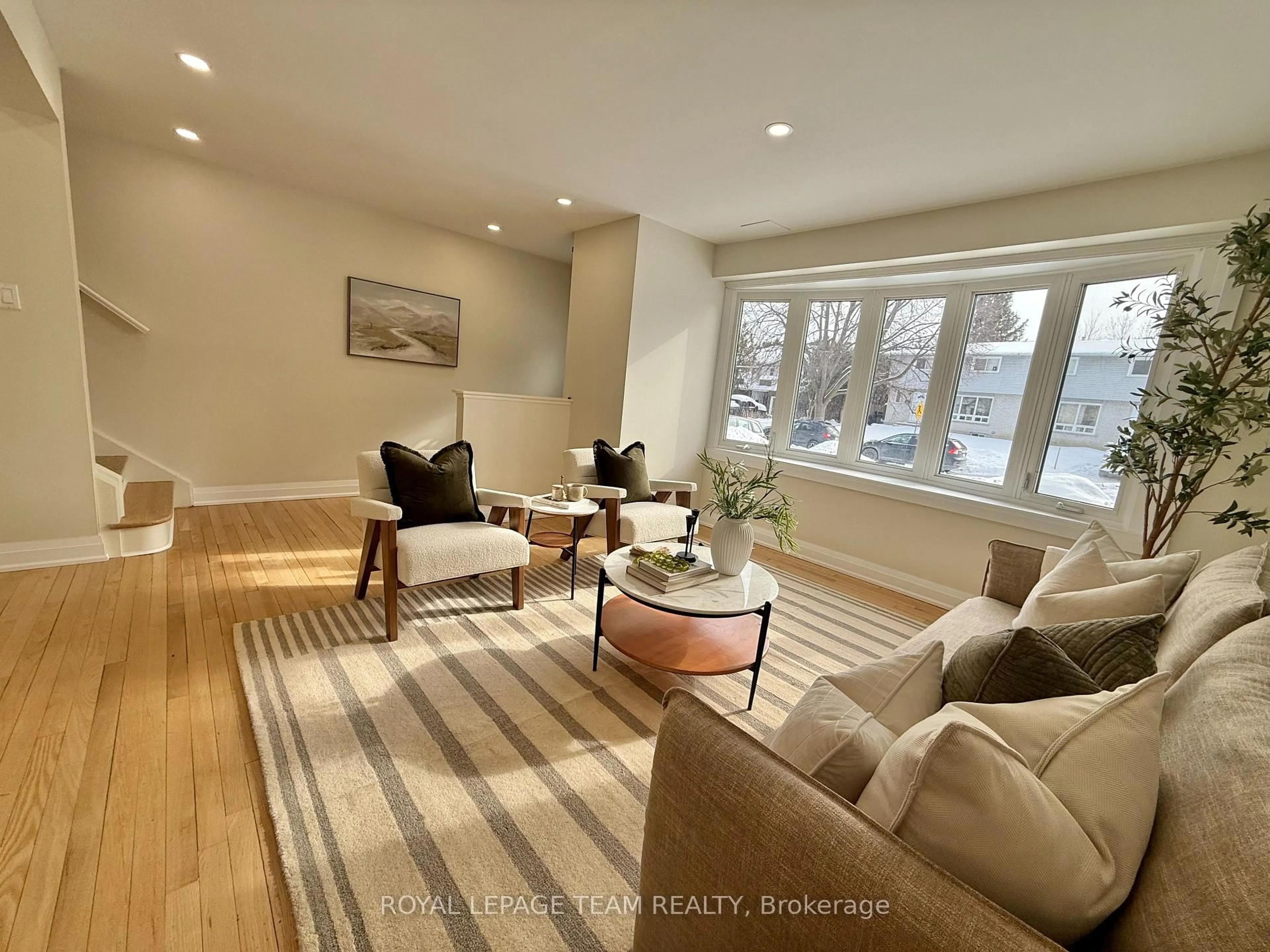 Living room with furniture, wood/laminate floor for 973 Eiffel Ave, Ottawa Ontario K2C 0J3