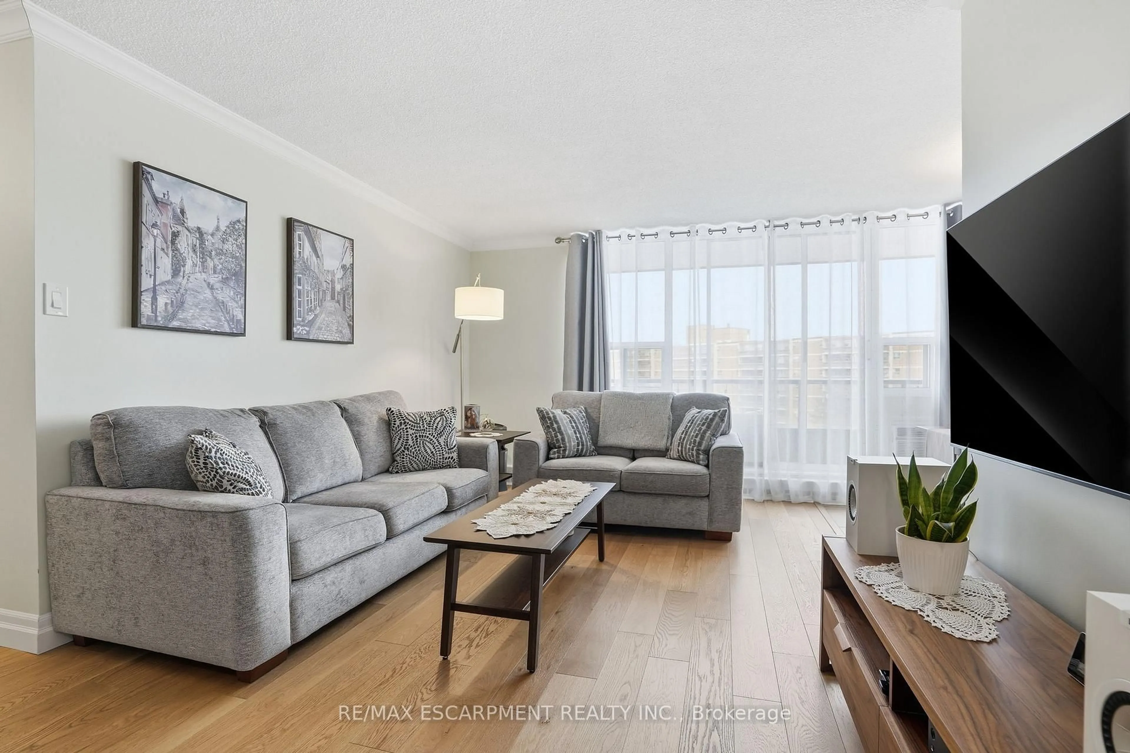 Living room with furniture, wood/laminate floor for 1966 Main St #1001, Hamilton Ontario L8S 1J6