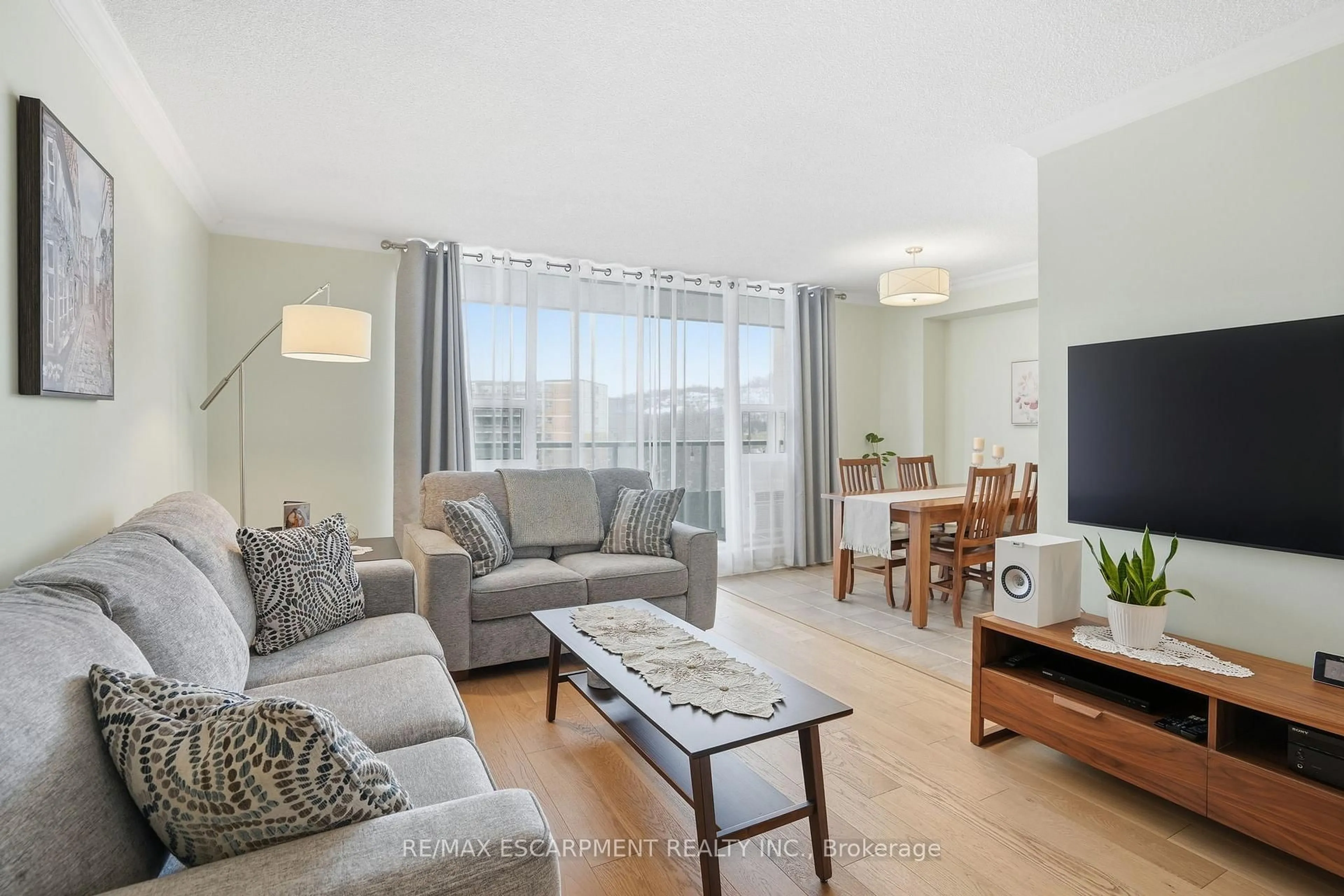 Living room with furniture, wood/laminate floor for 1966 Main St #1001, Hamilton Ontario L8S 1J6