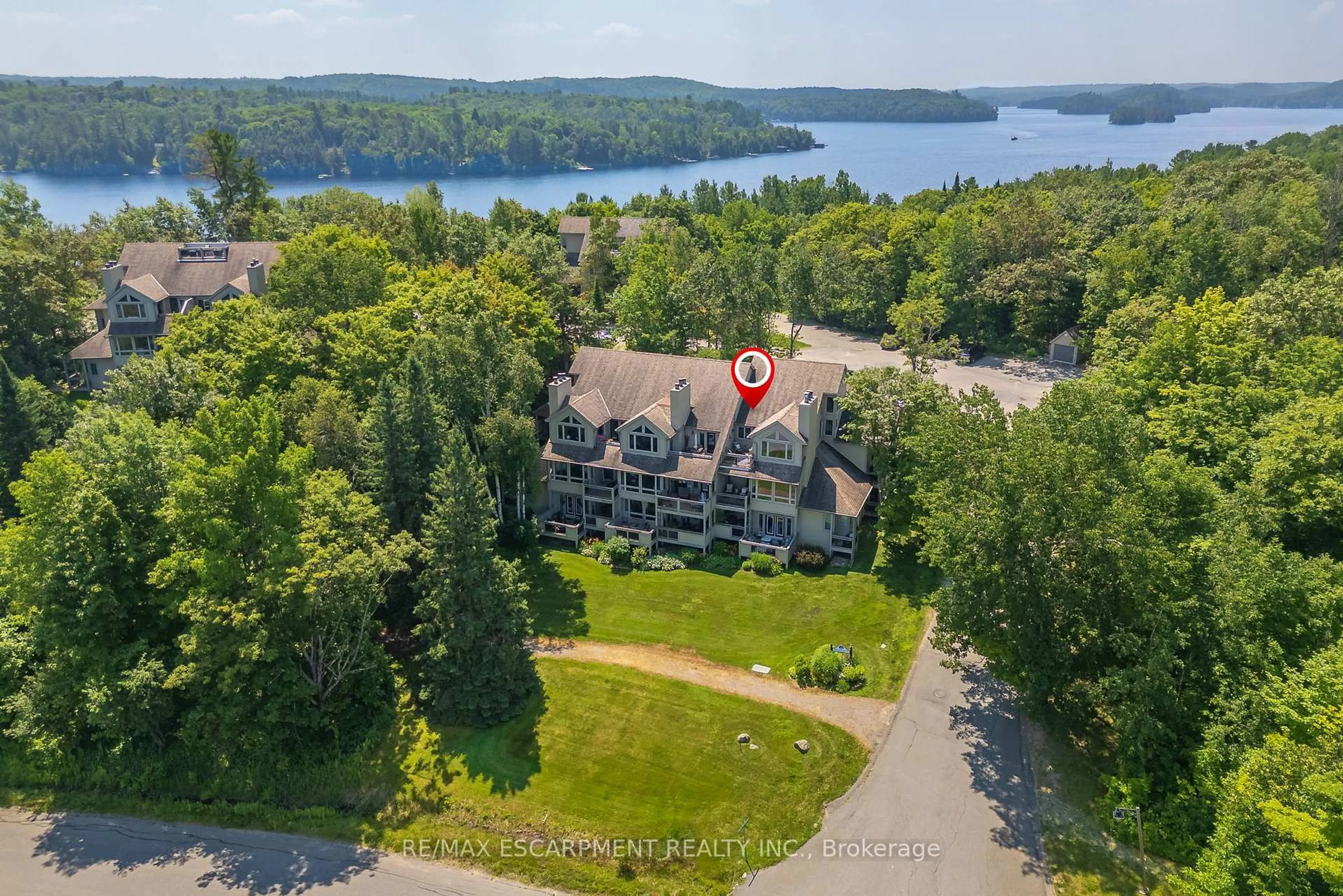 A pic from outside/outdoor area/front of a property/back of a property/a pic from drone, water/lake/river/ocean view for 131 Grandview Hilltop Dr #1, Huntsville Ontario P1H 2J5