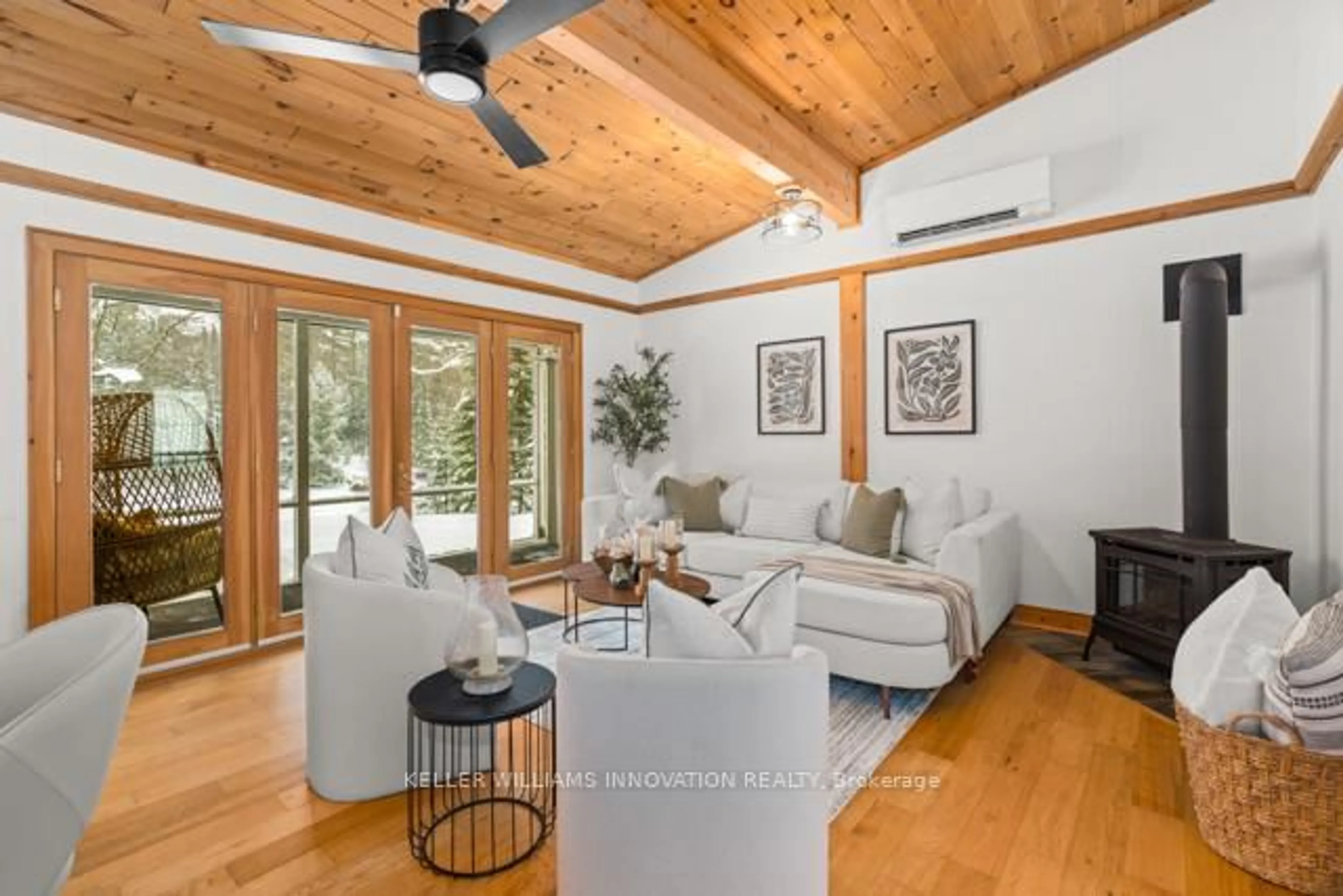 Living room with furniture, wood/laminate floor for 1217 Sherwood Frst Rd, Bracebridge Ontario P1L 1X3