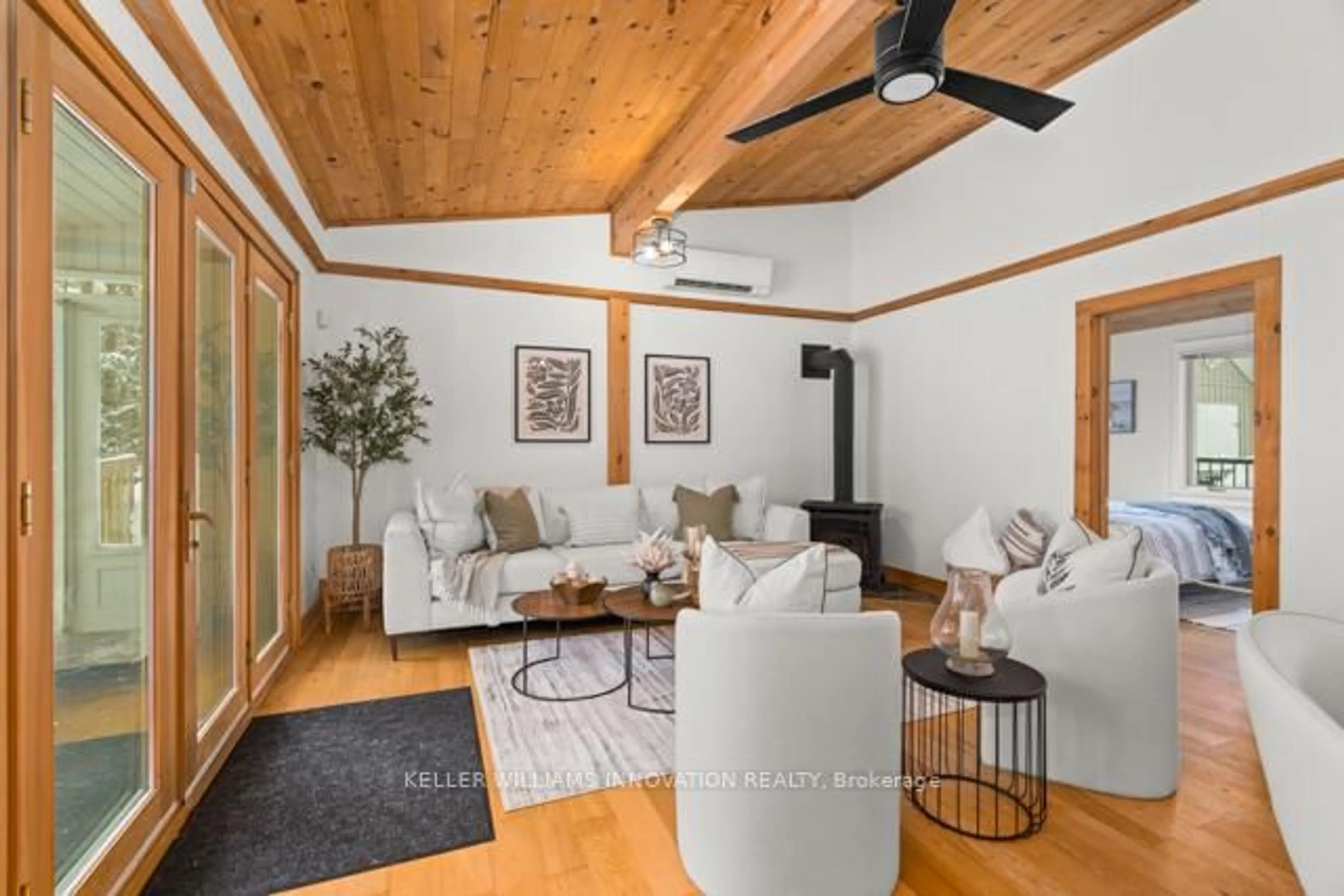 Living room with furniture, wood/laminate floor for 1217 Sherwood Frst Rd, Bracebridge Ontario P1L 1X3