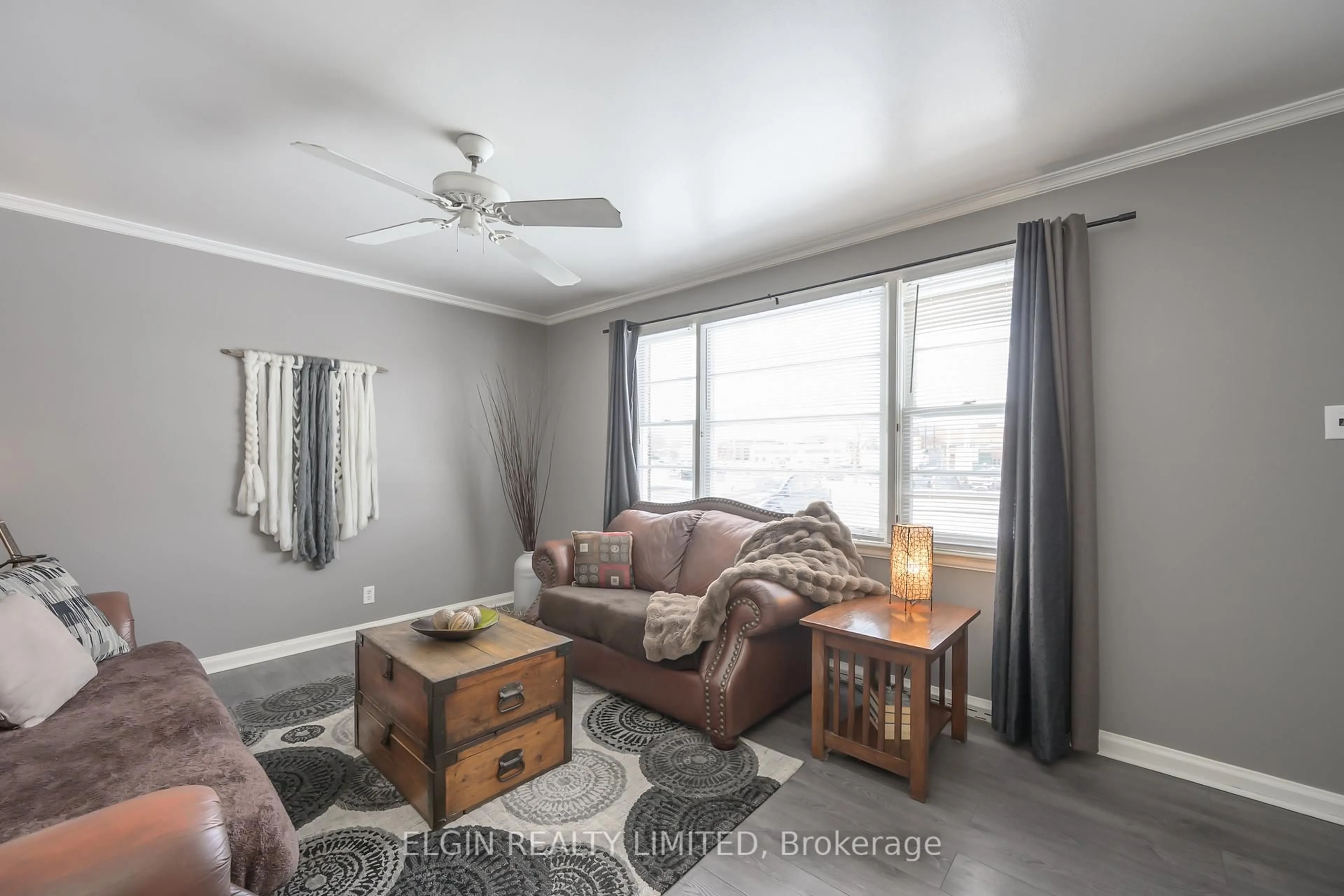 Living room with furniture, wood/laminate floor for 12 Wood St, St. Thomas Ontario N5R 4K9