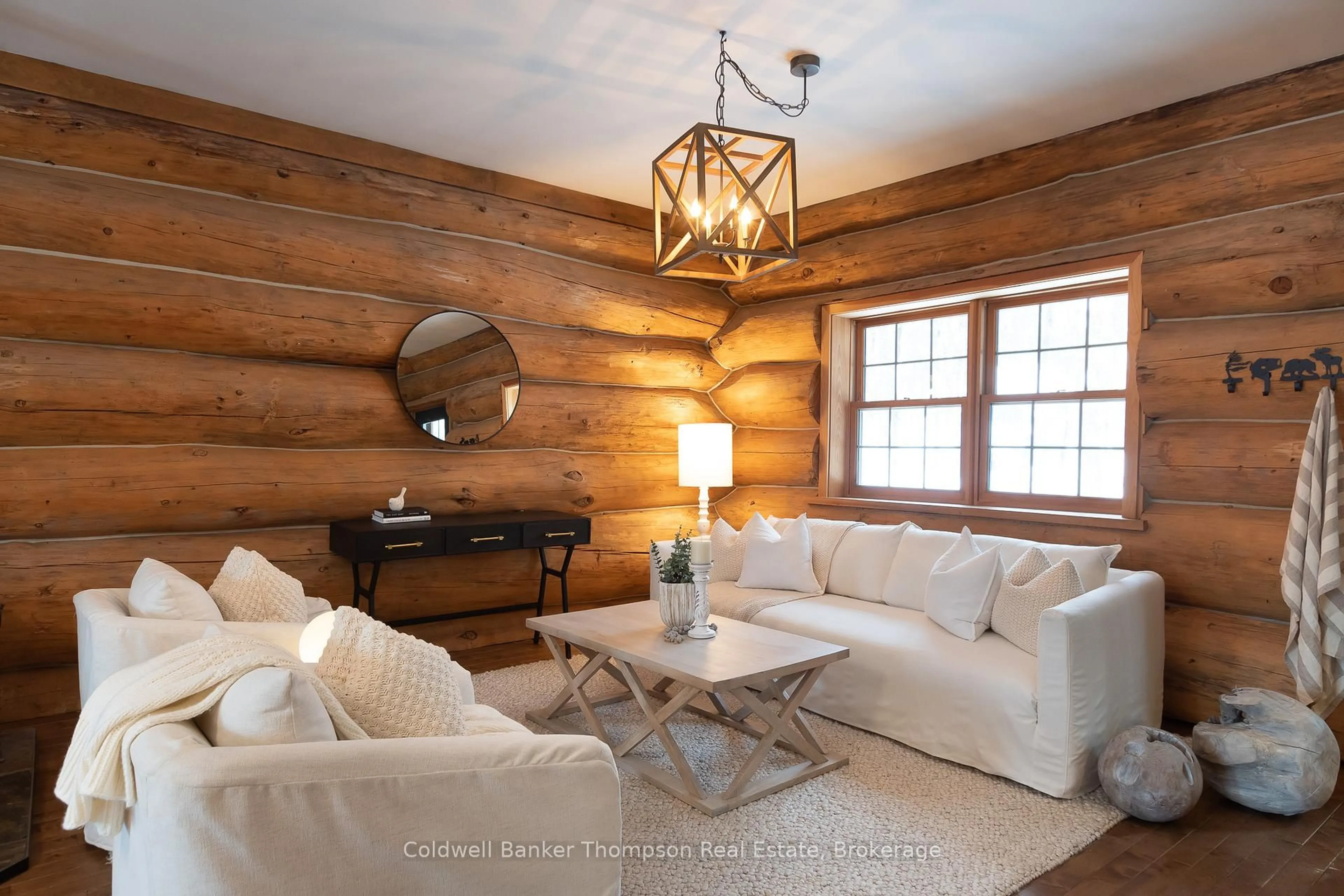 Living room with furniture, wood/laminate floor for 299 Rowanwood Rd, Huntsville Ontario P0B 1M0