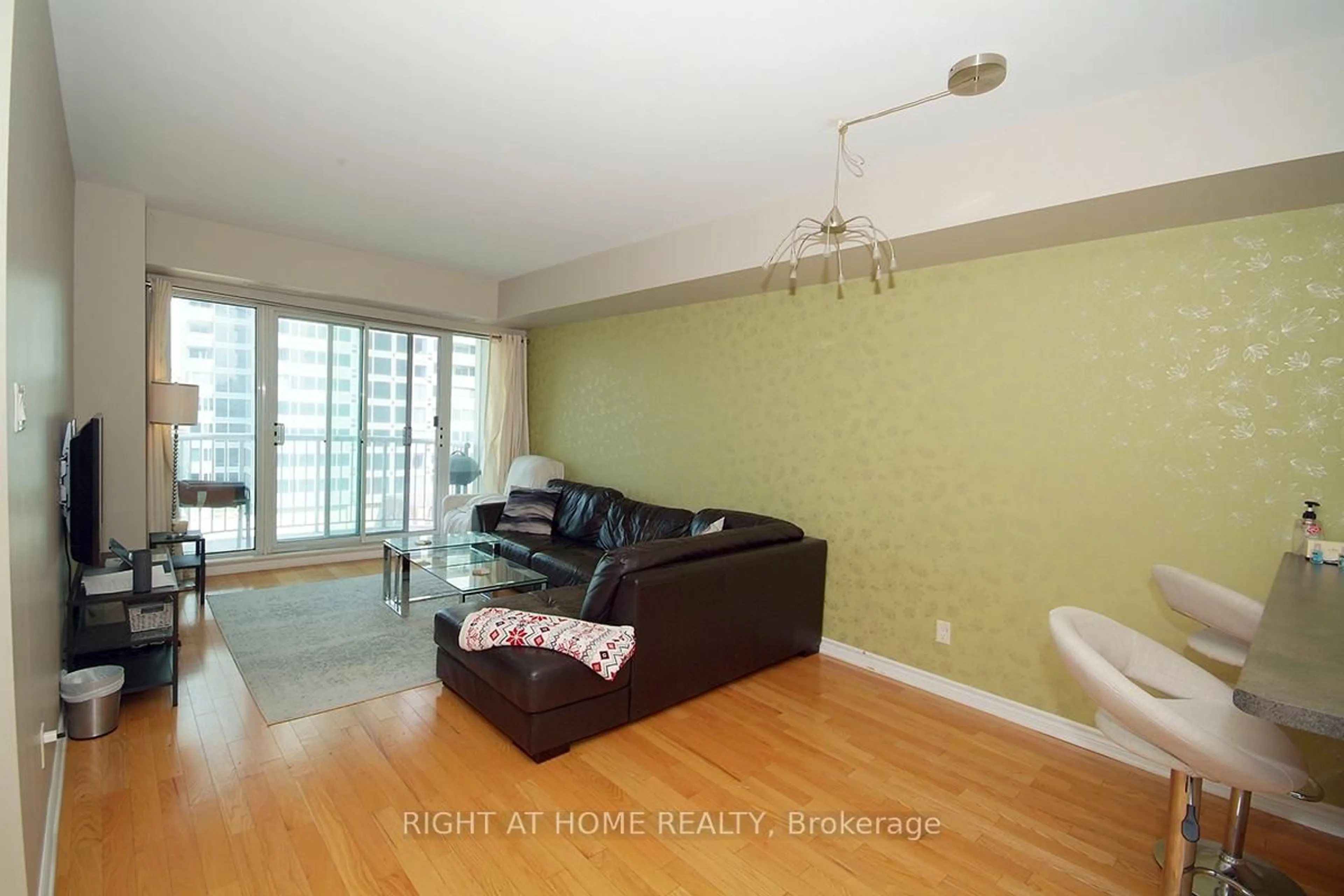 Living room with furniture, wood/laminate floor for 200 Rideau St #702, Ottawa Ontario K1N 5Y1