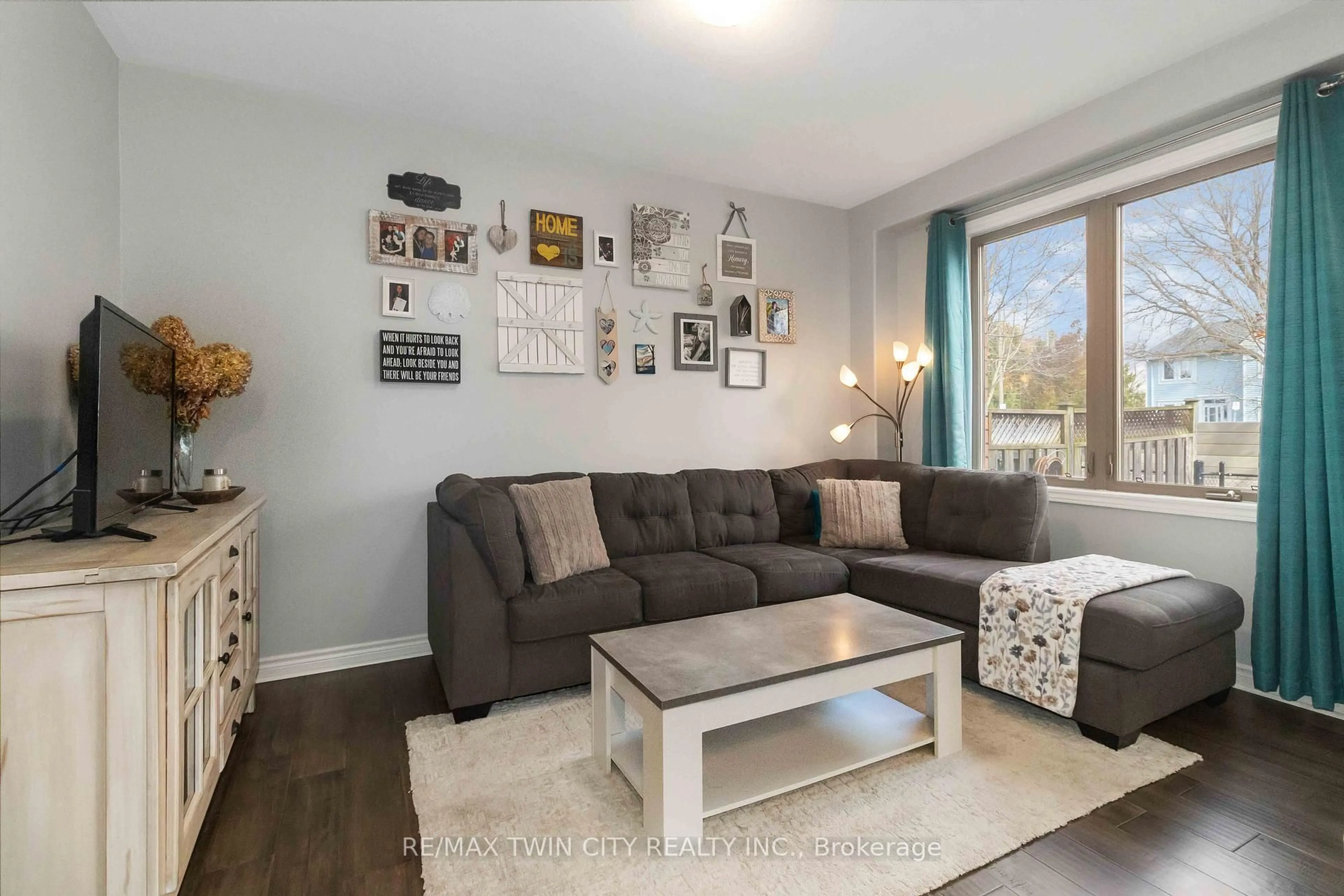 Living room with furniture, wood/laminate floor for 12 Brantwood Park Rd #D2, Brantford Ontario N3P 1G2