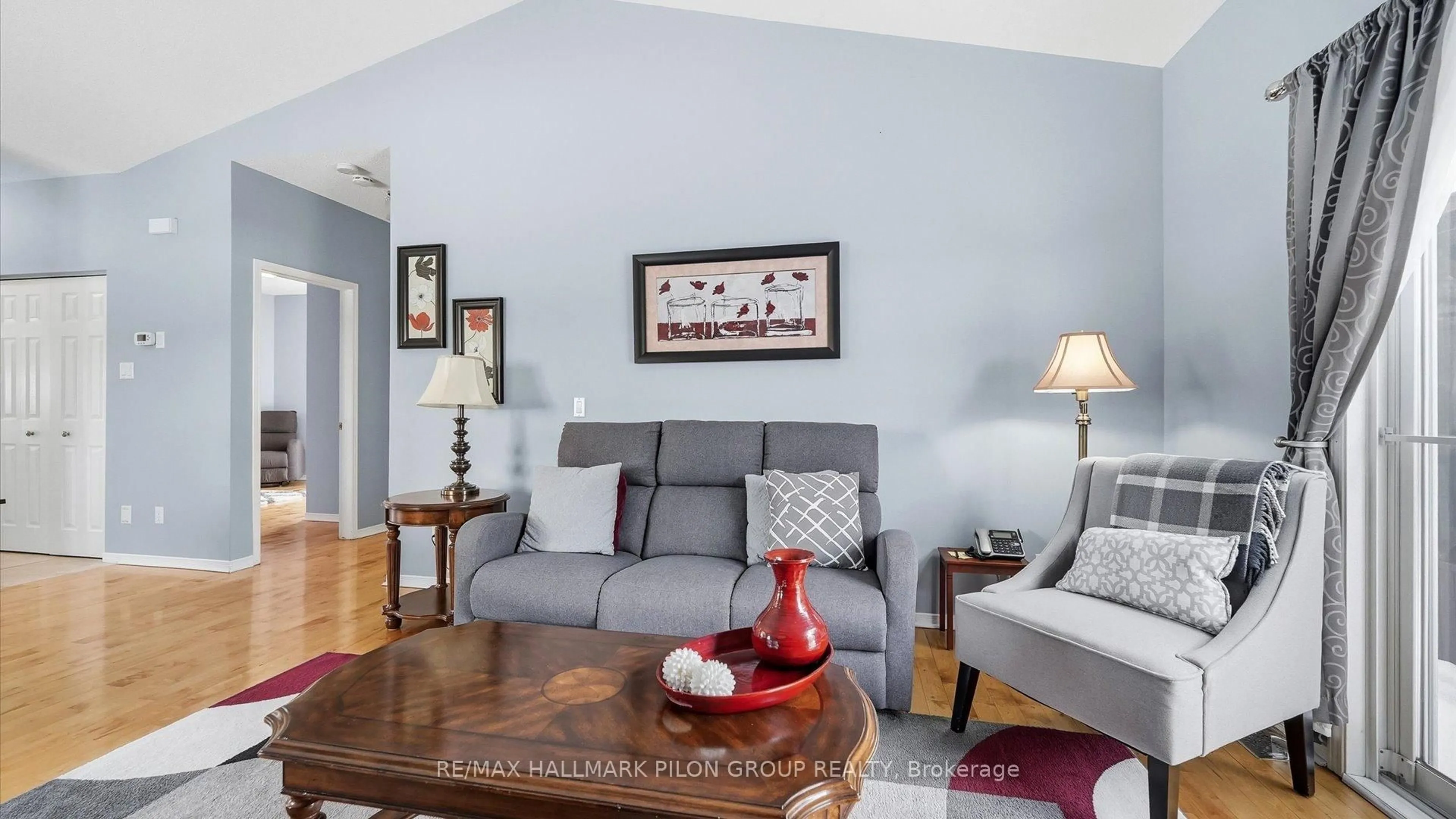 Living room with furniture, wood/laminate floor for 303 Rustic Hills Cres, Orleans Ontario K4A 5A5