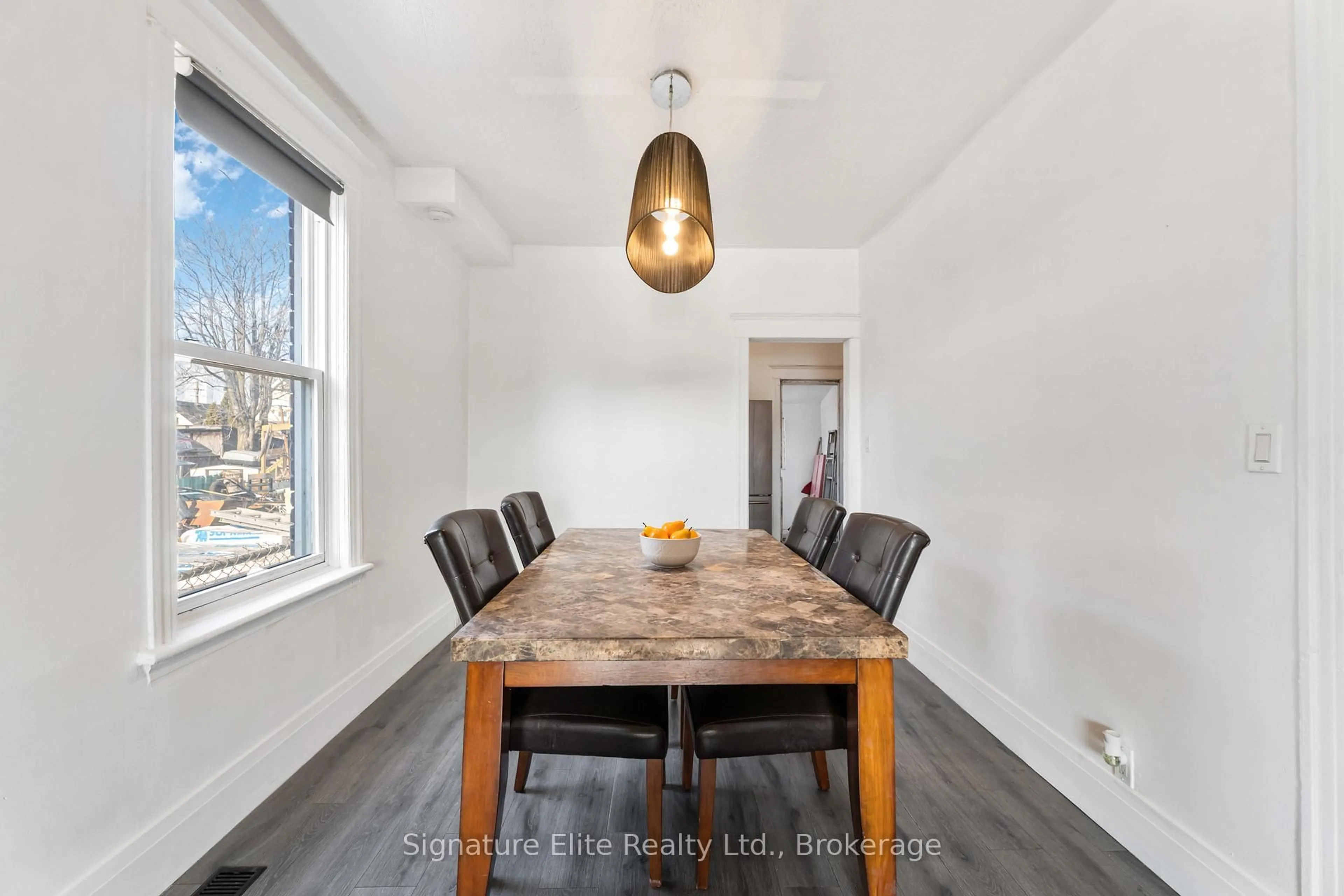 Dining room, wood/laminate floor for 67 Beach Rd, Hamilton Ontario L8L 3Z6