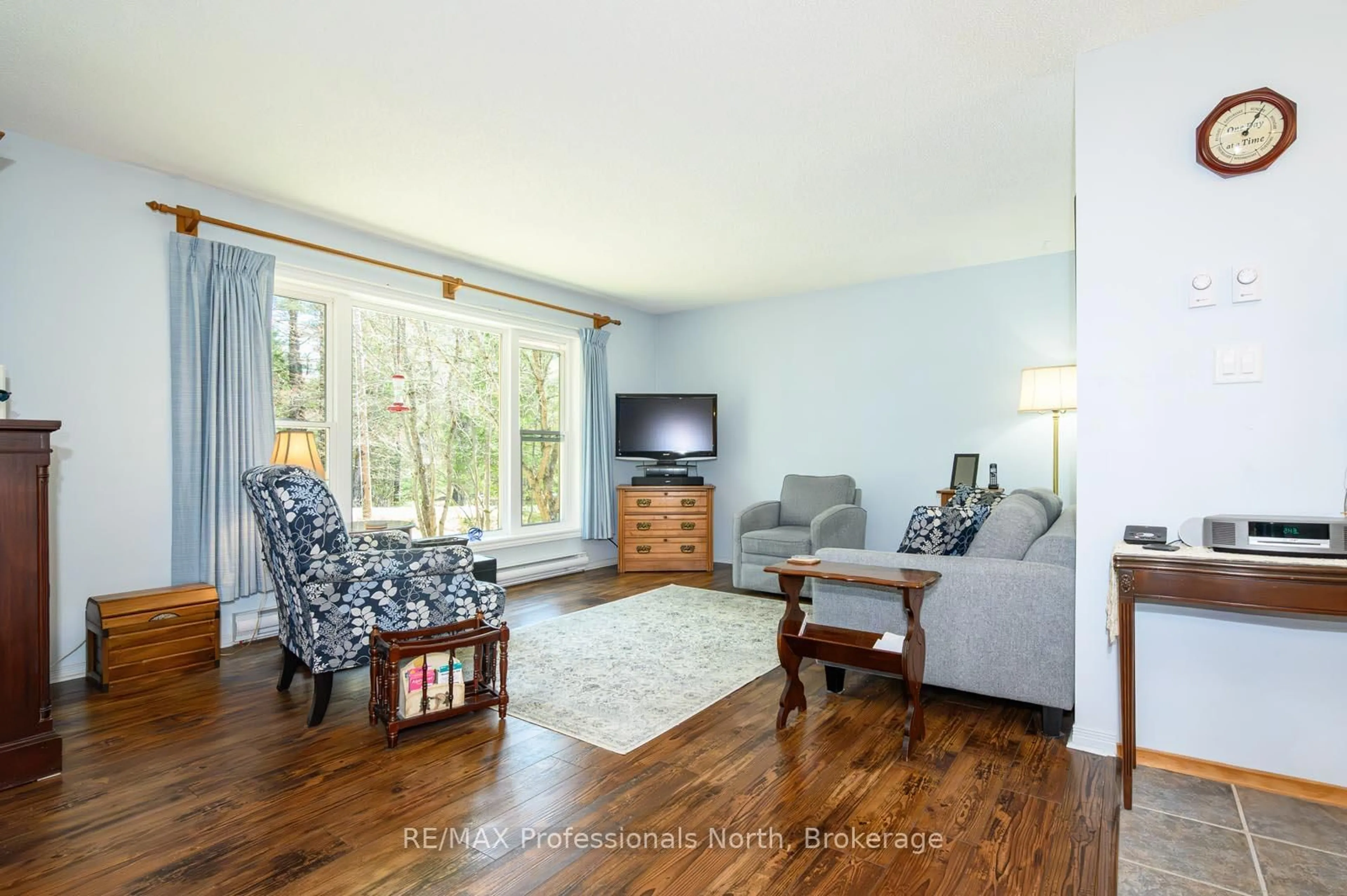 Living room with furniture, wood/laminate floor for 224 Stephenson 4 Rd, Huntsville Ontario P0B 1M0