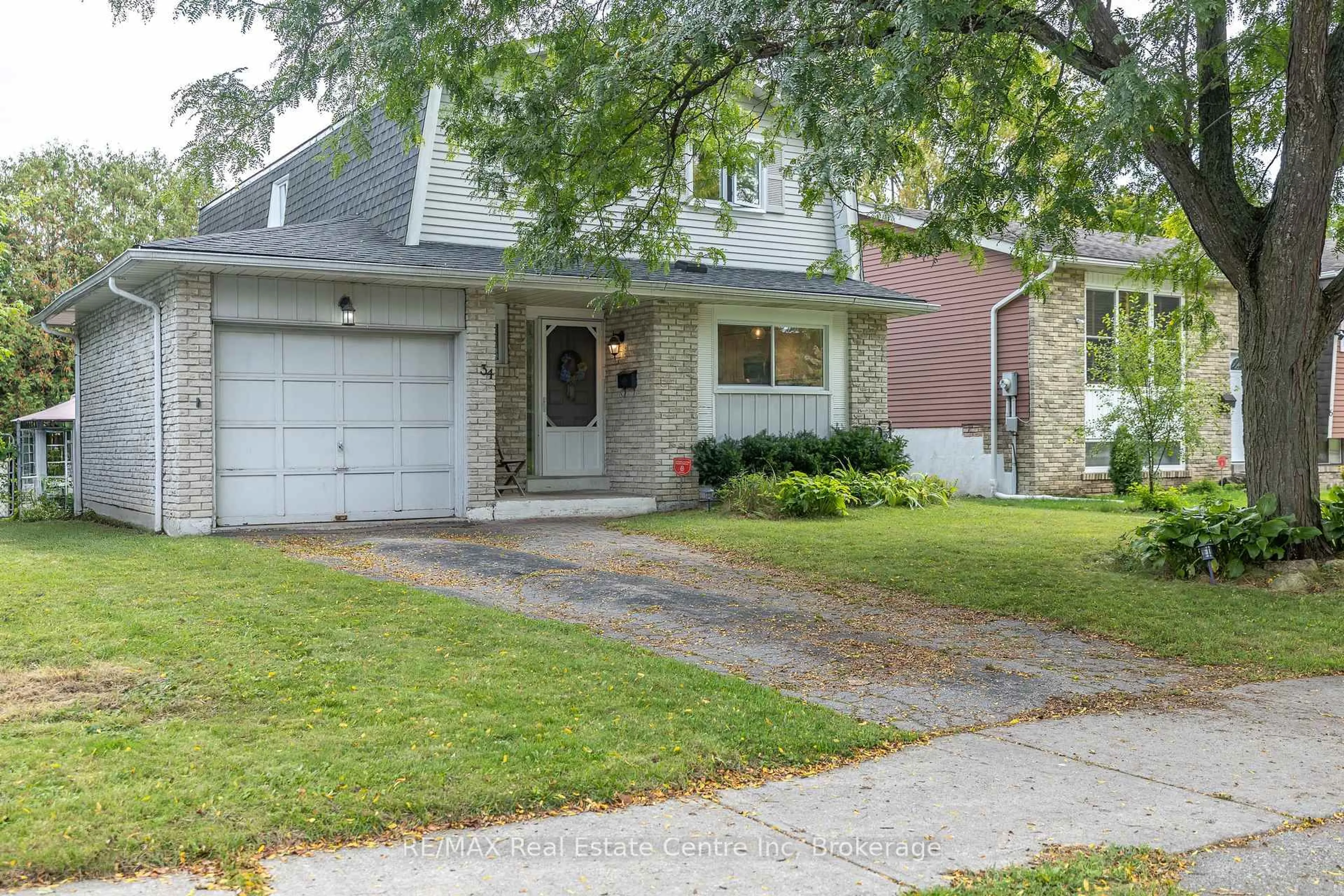 Home with brick exterior material, street for 34 Woodridge Dr, Guelph Ontario N1H 7E2