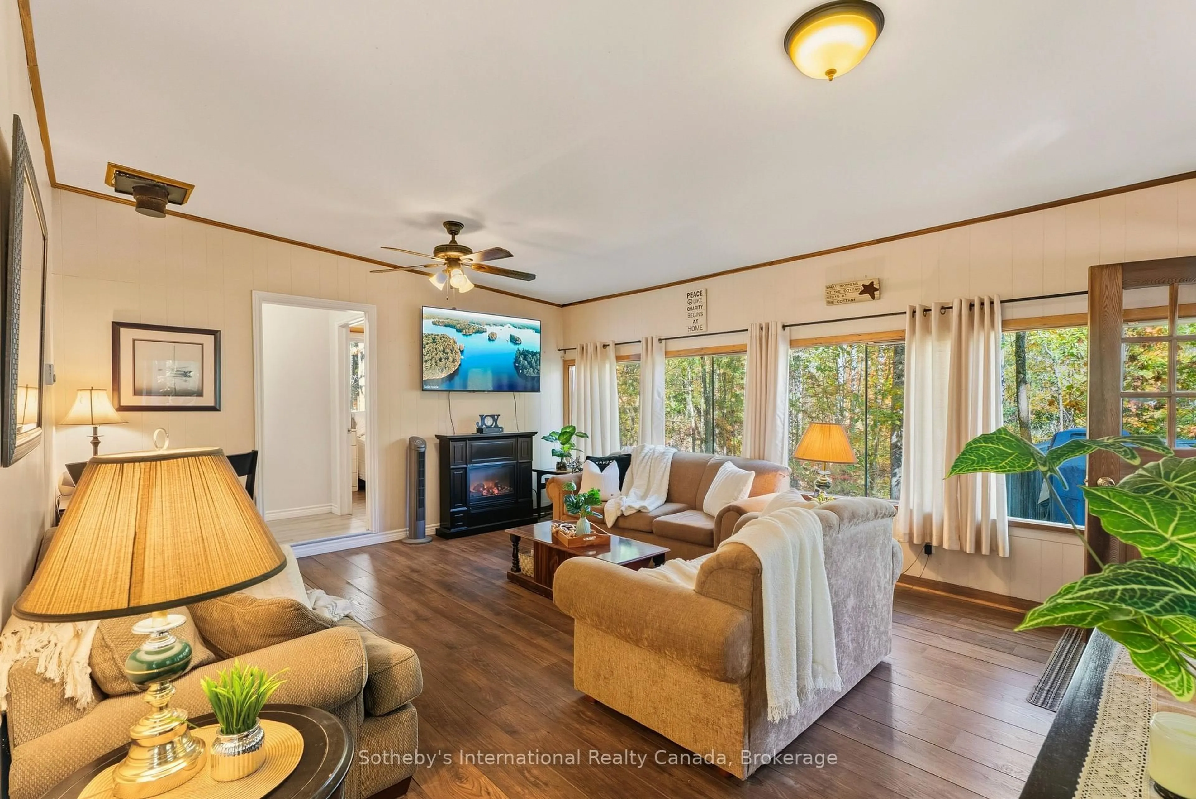 Living room with furniture, wood/laminate floor for 1161 North Kahshe Lake Rd, Gravenhurst Ontario P0E 1G0