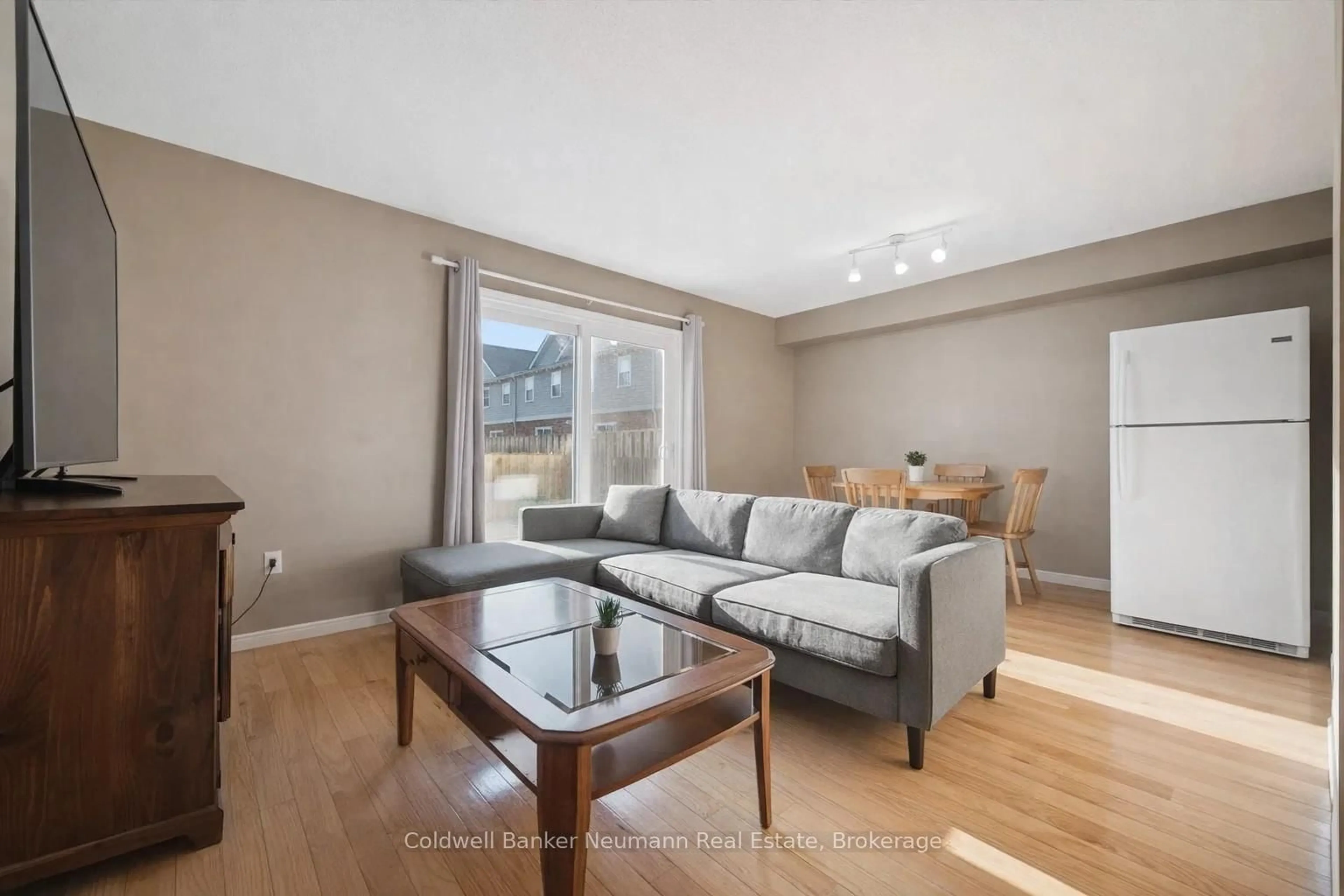 Living room with furniture, wood/laminate floor for 124 Gosling Gdns #33, Guelph Ontario N1G 5K6