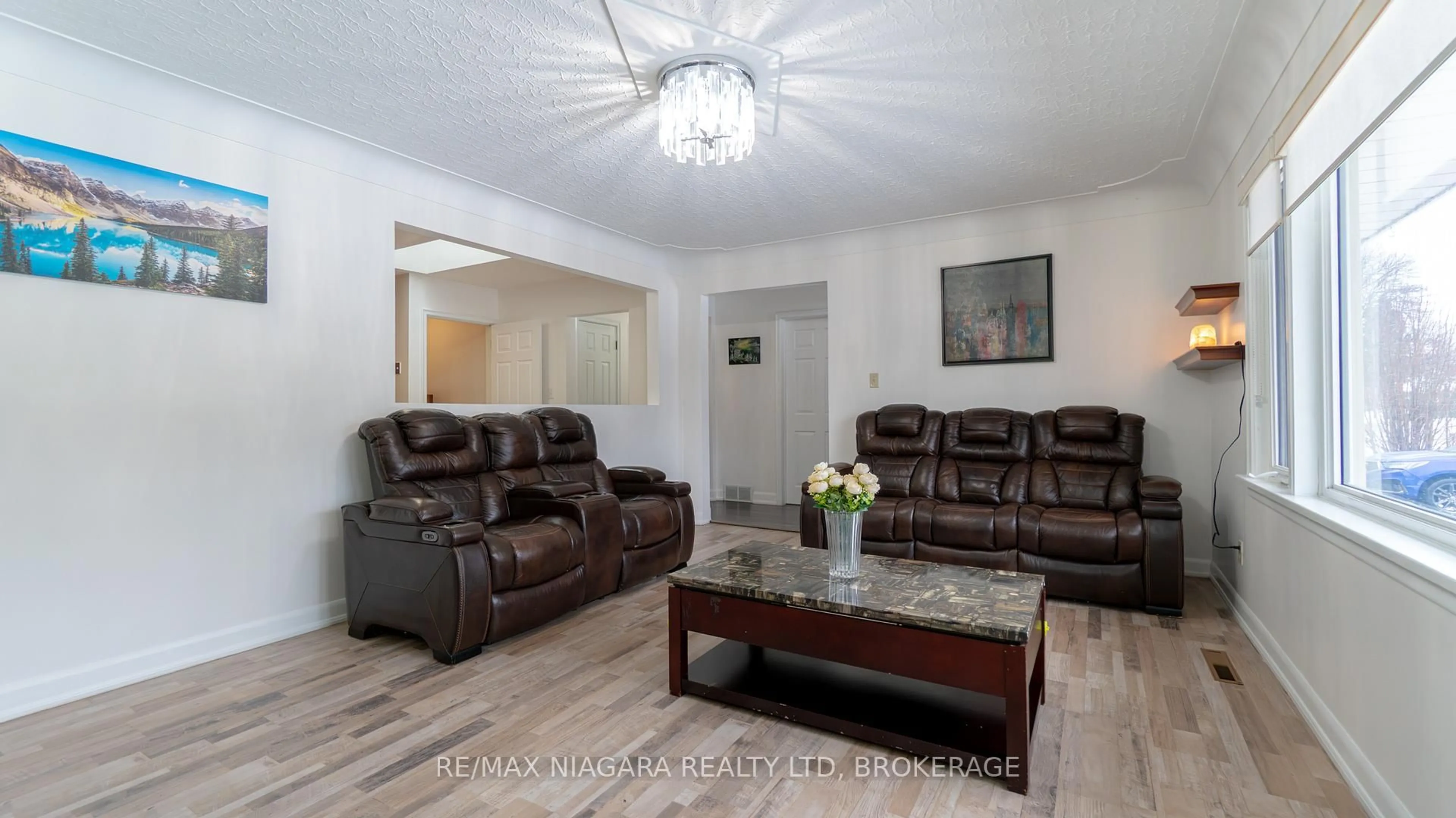 Living room with furniture, wood/laminate floor for 6543 ST. JOHN St, Niagara Falls Ontario L2J 1C8