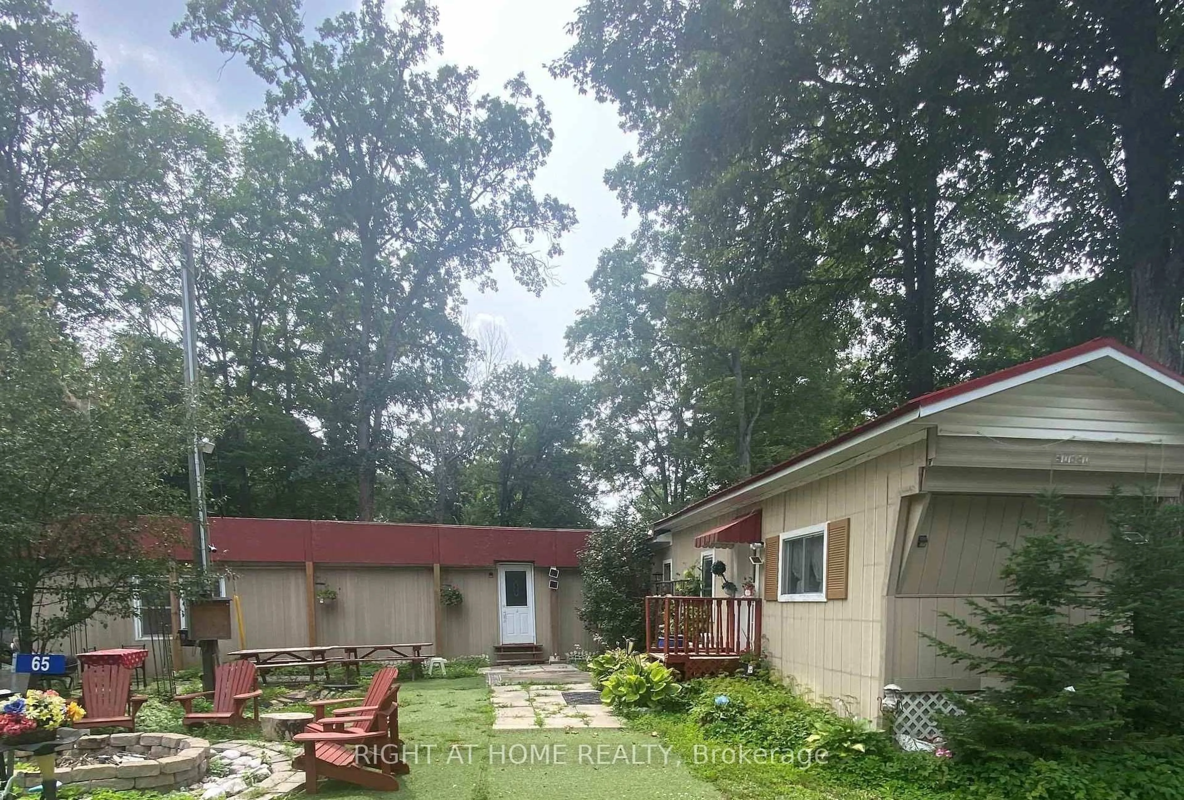 A pic from outside/outdoor area/front of a property/back of a property/a pic from drone, forest/trees view for 65 Cedar Lane, Trent Hills Ontario K0K 2M0