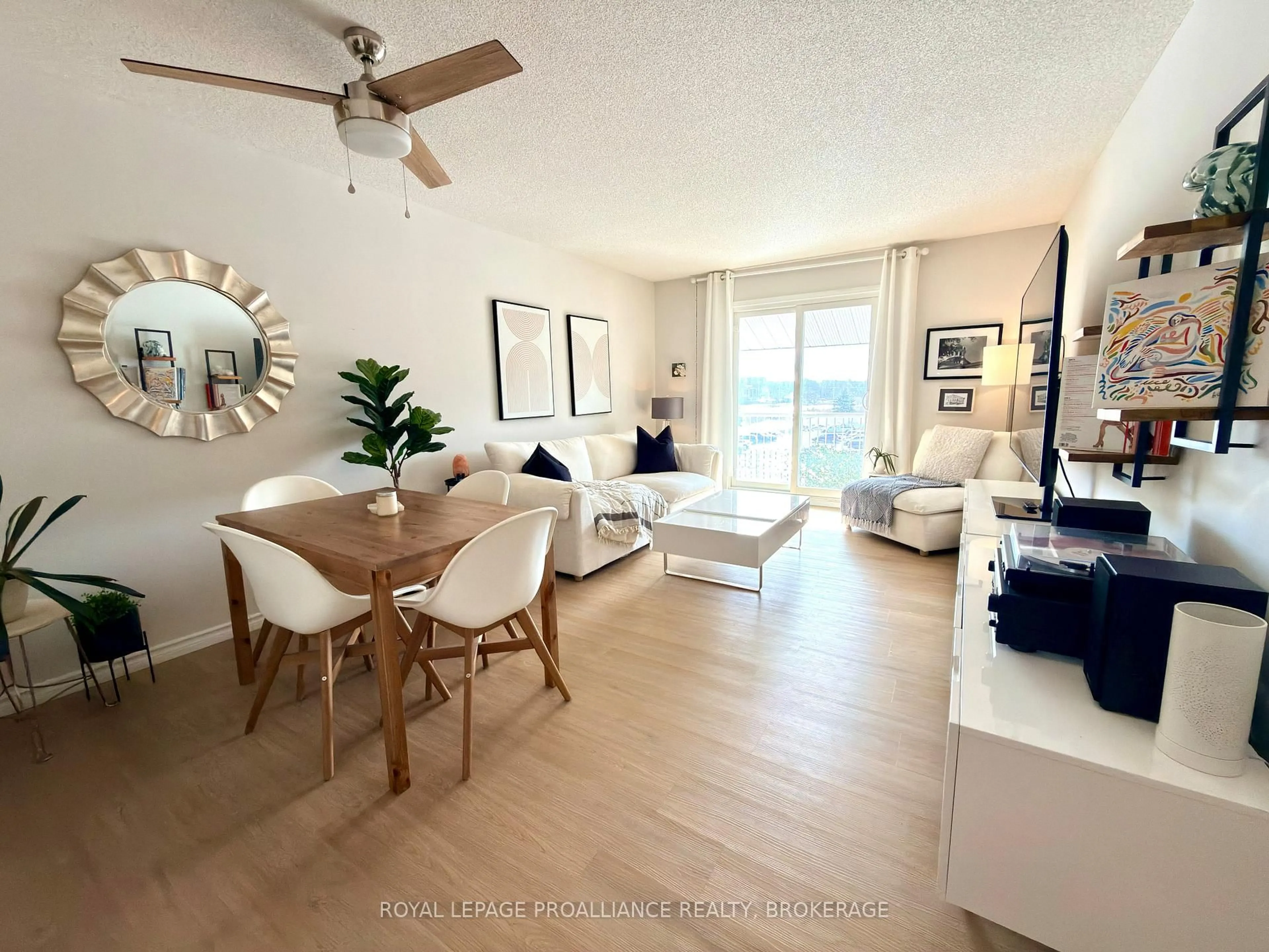 Living room with furniture, wood/laminate floor for 580 Armstrong Rd #411, Kingston Ontario K7M 8M3