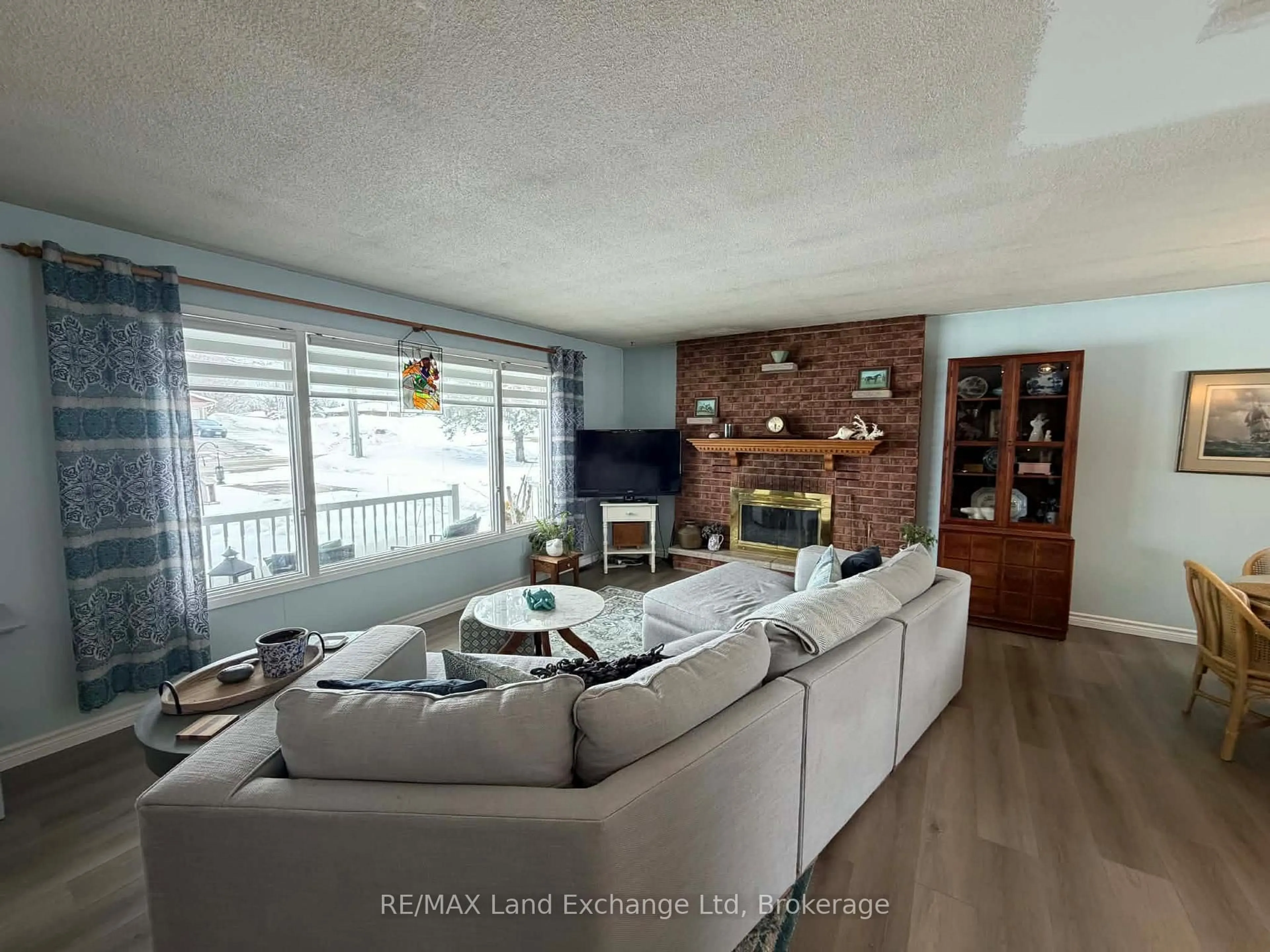 Living room with furniture, wood/laminate floor for 19 Mccrea St, Morris Turnberry Ontario N0G 1H0